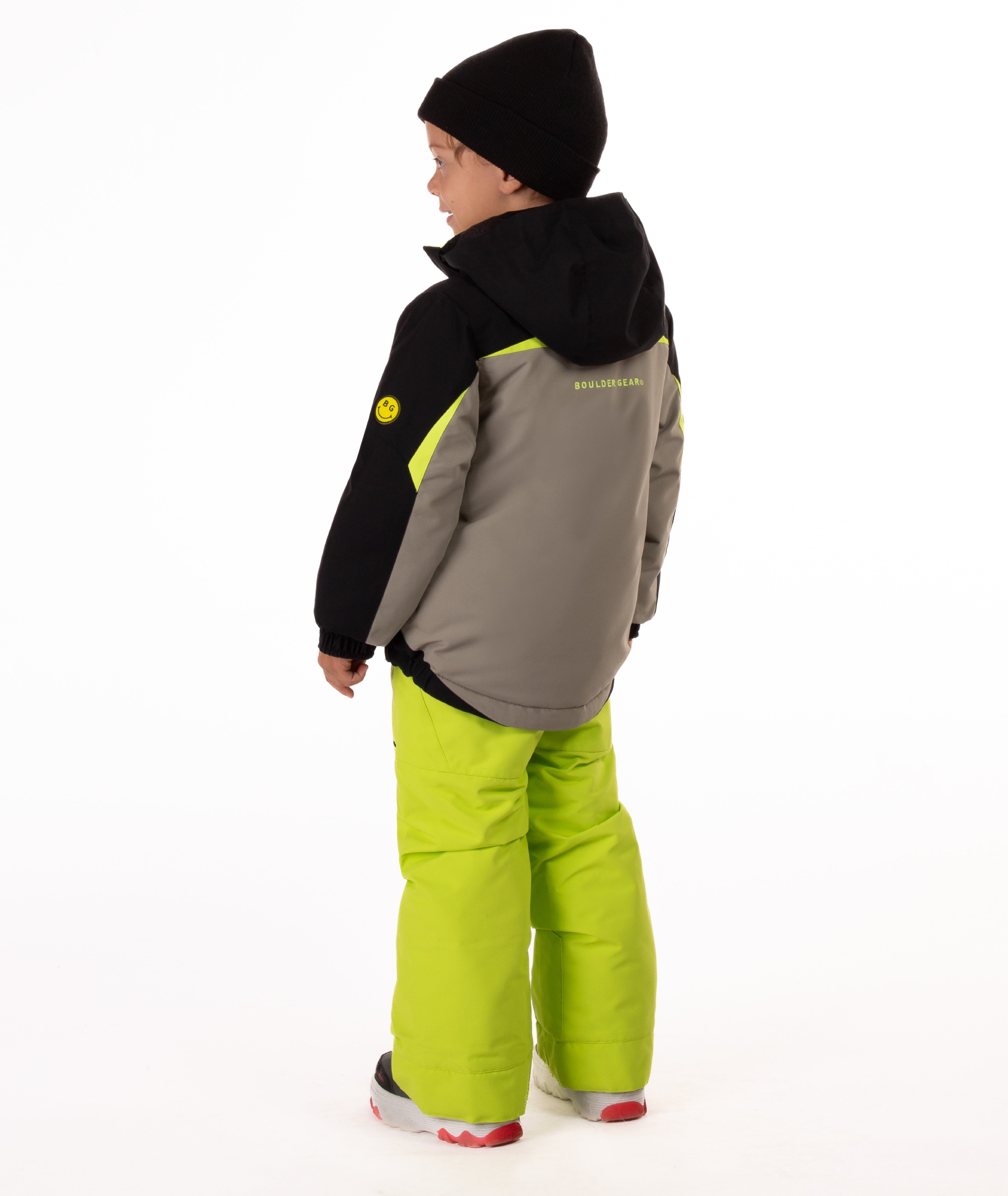 Child wearing an black and grey insulated winter jacket with bright lime trim showing the black hood and visible Boulder Gear brand logo on center back of jacket