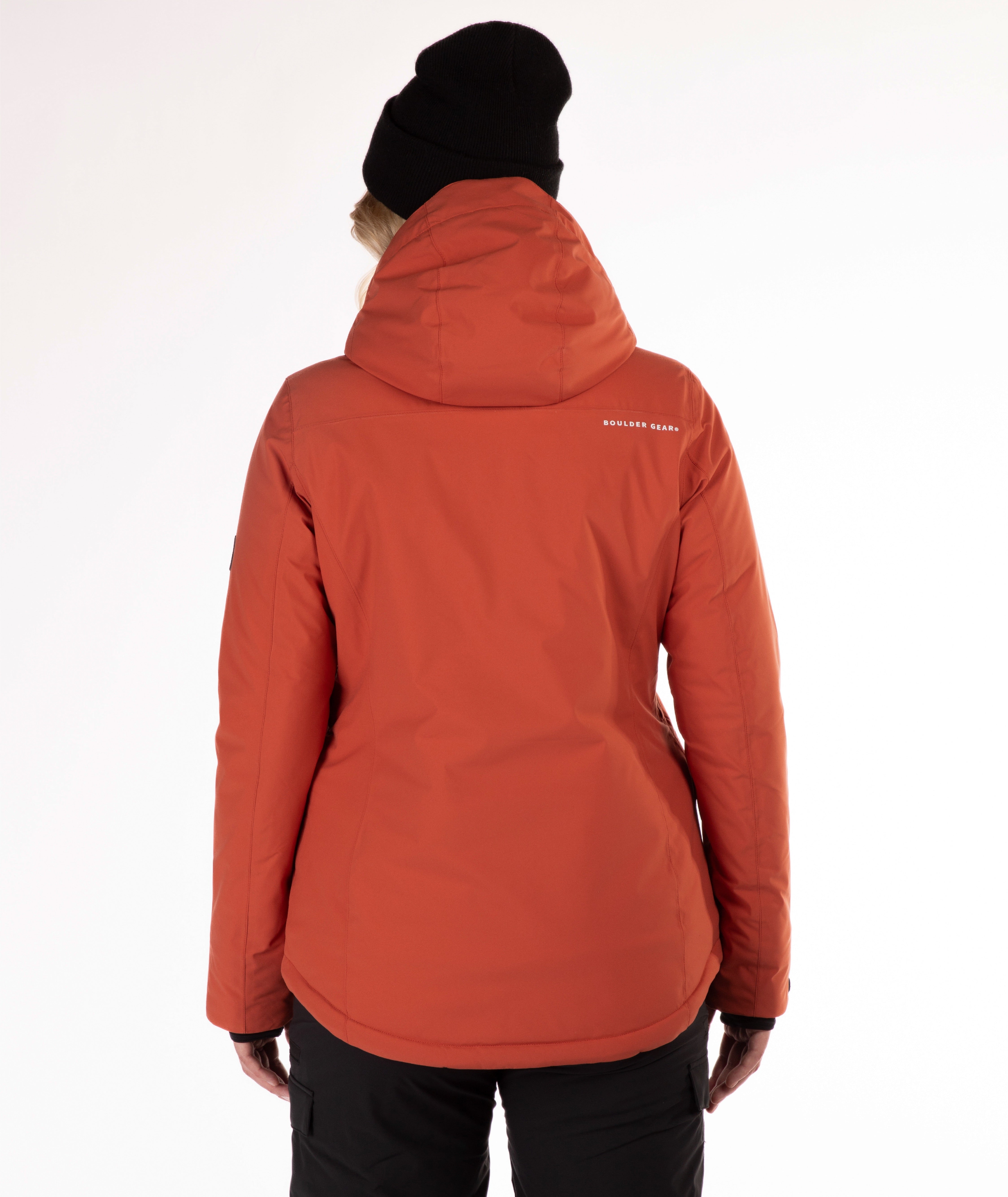 back of a woman wearing a rust colored winter jacket on a white background