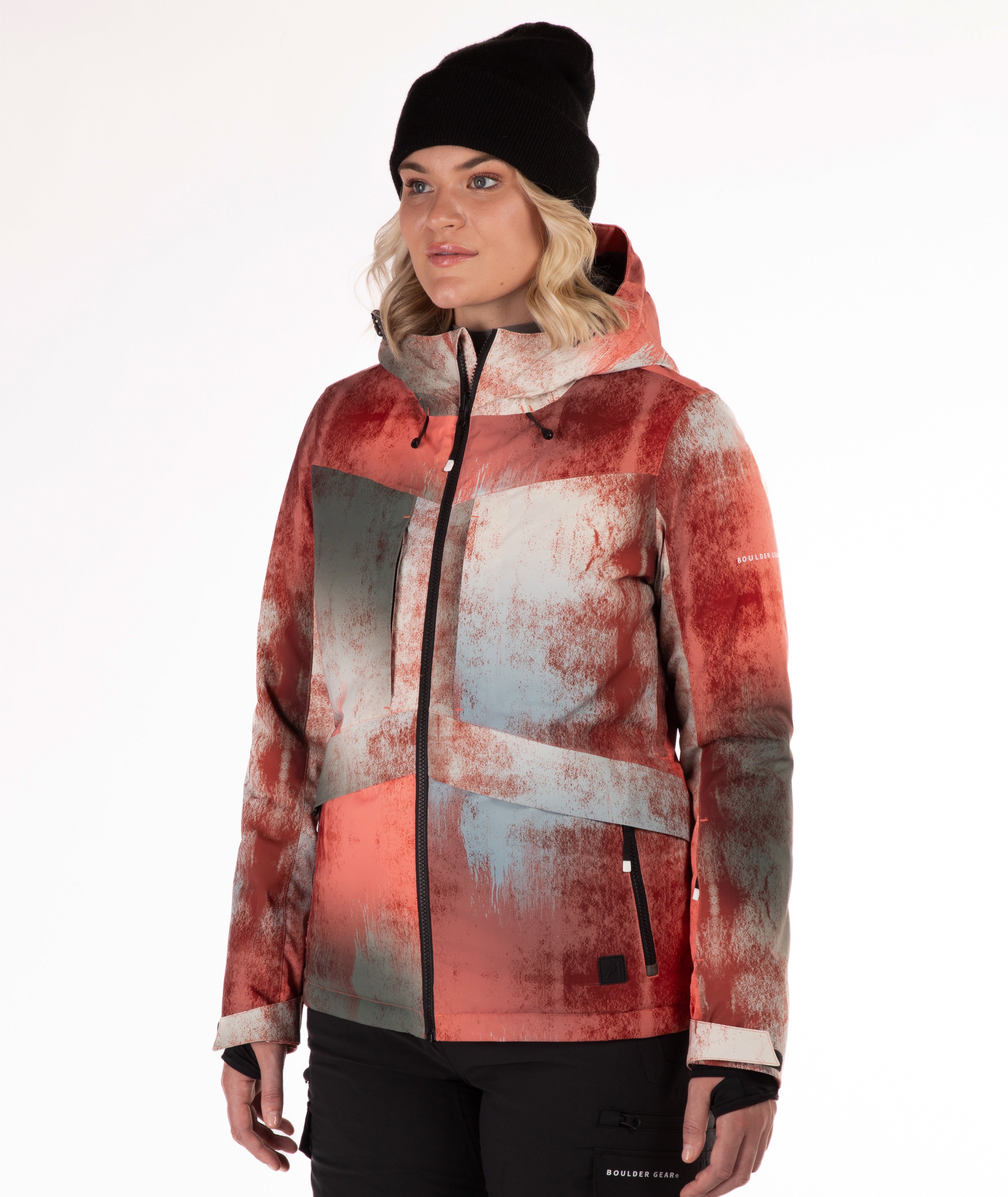 Person wearing an abstract printed jacket in primarily rust, gray and beige with a white background