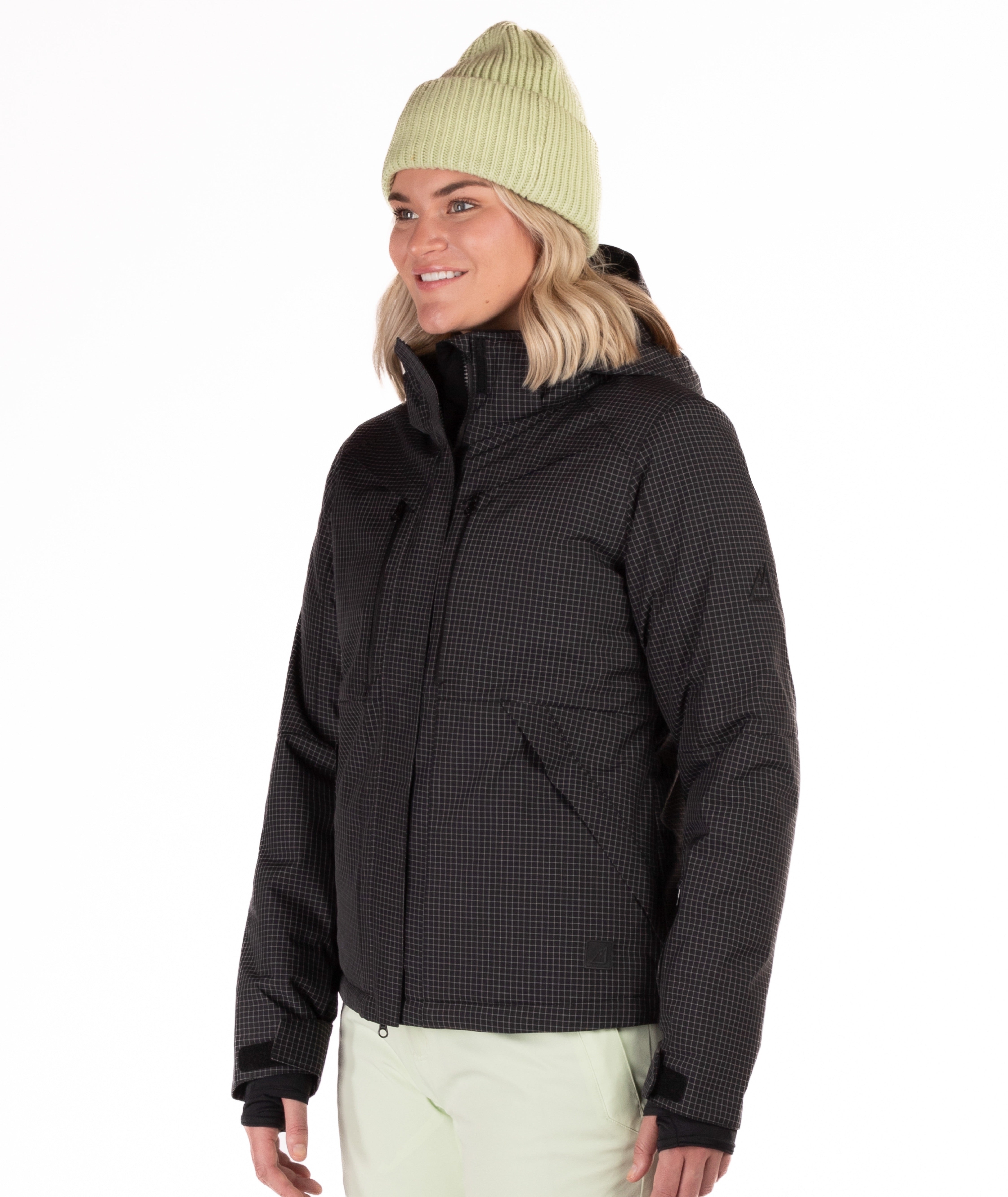 Person wearing a black checkered snow jacket on a white background