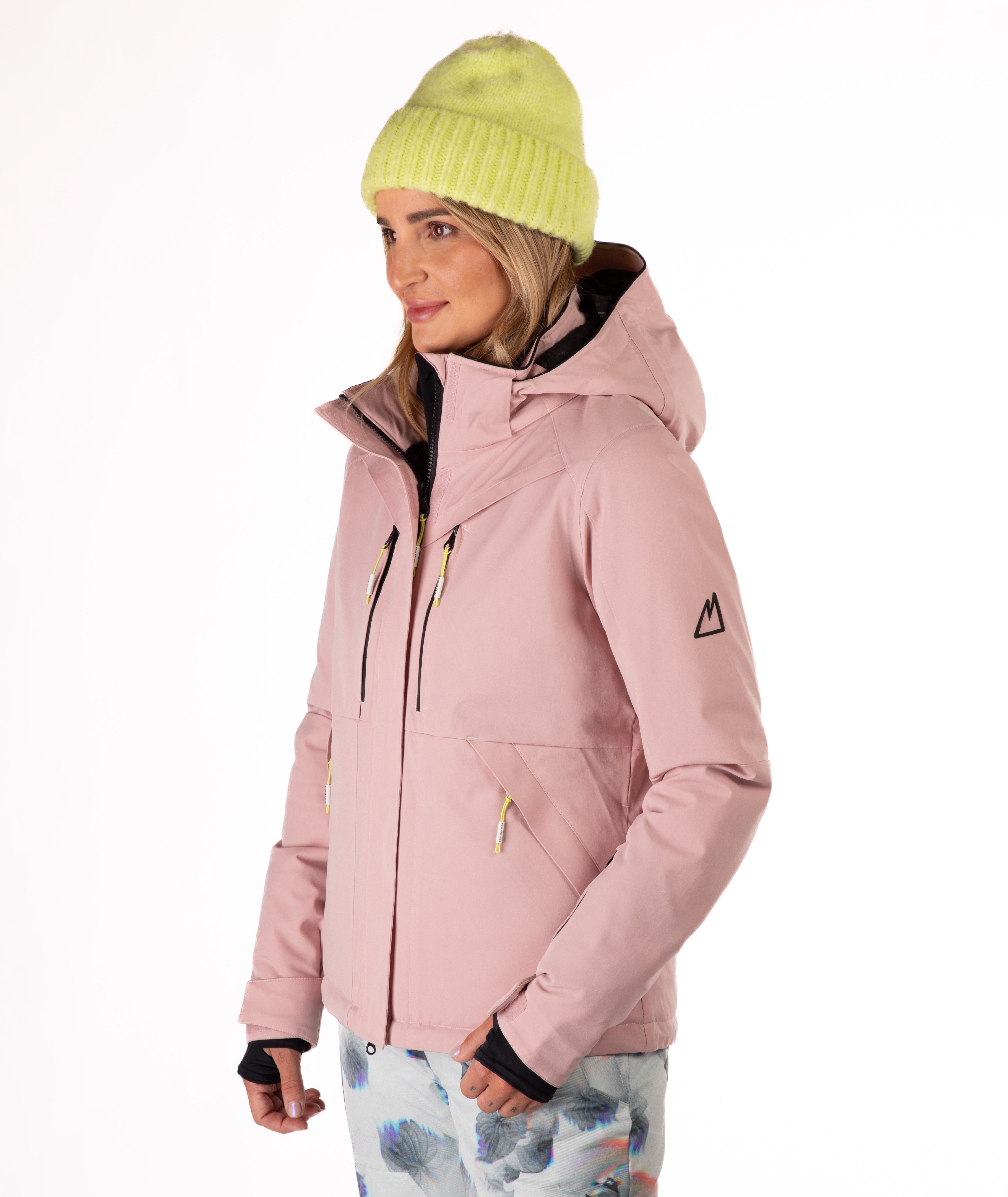 Woman wearing a pink jacket with black chest zippers on a white background