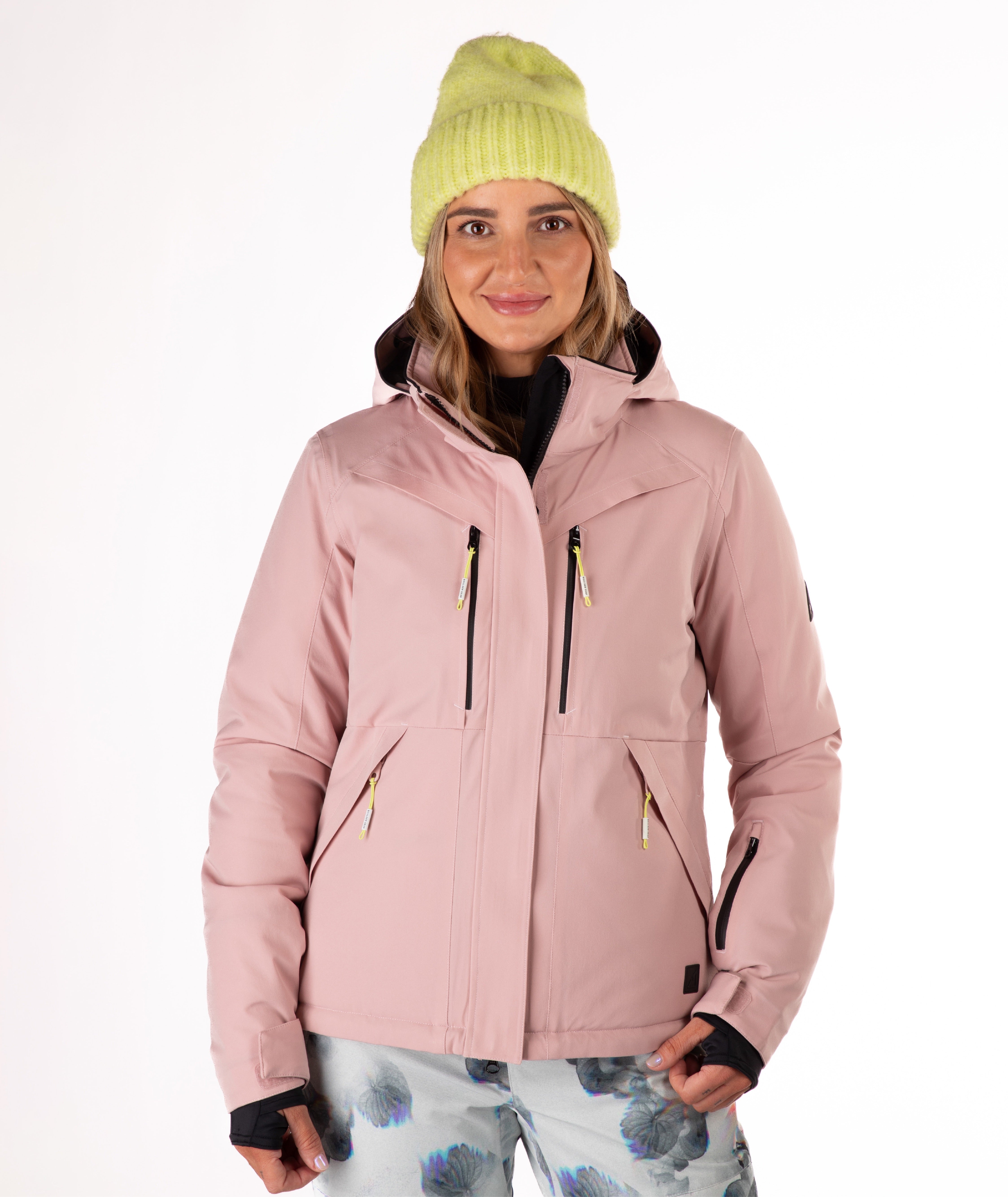 Woman wearing a pink jacket with black chest zippers on a white background