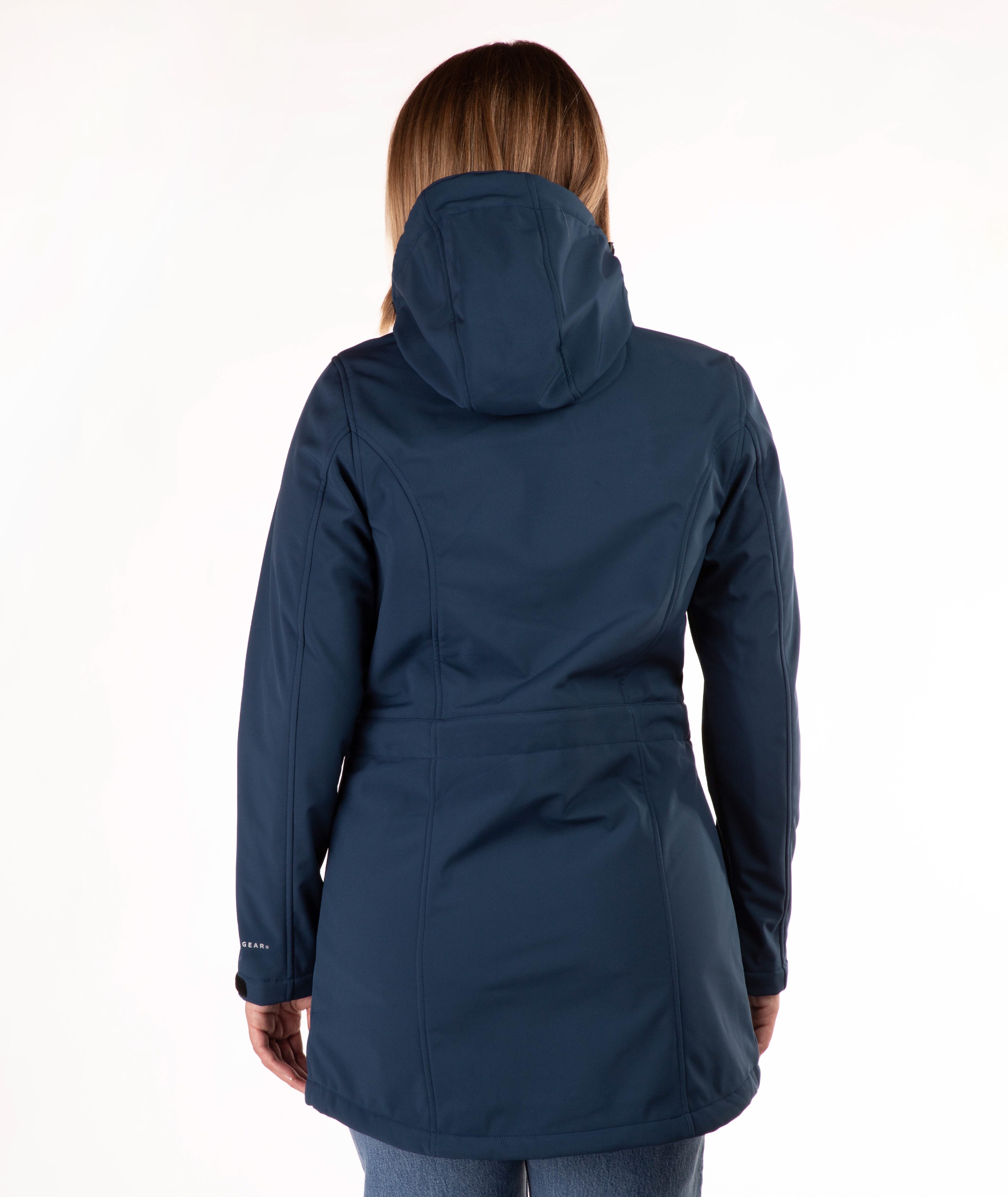 A woman viewed from the back wearing a dark navy hooded jacket against a plain white studio background.