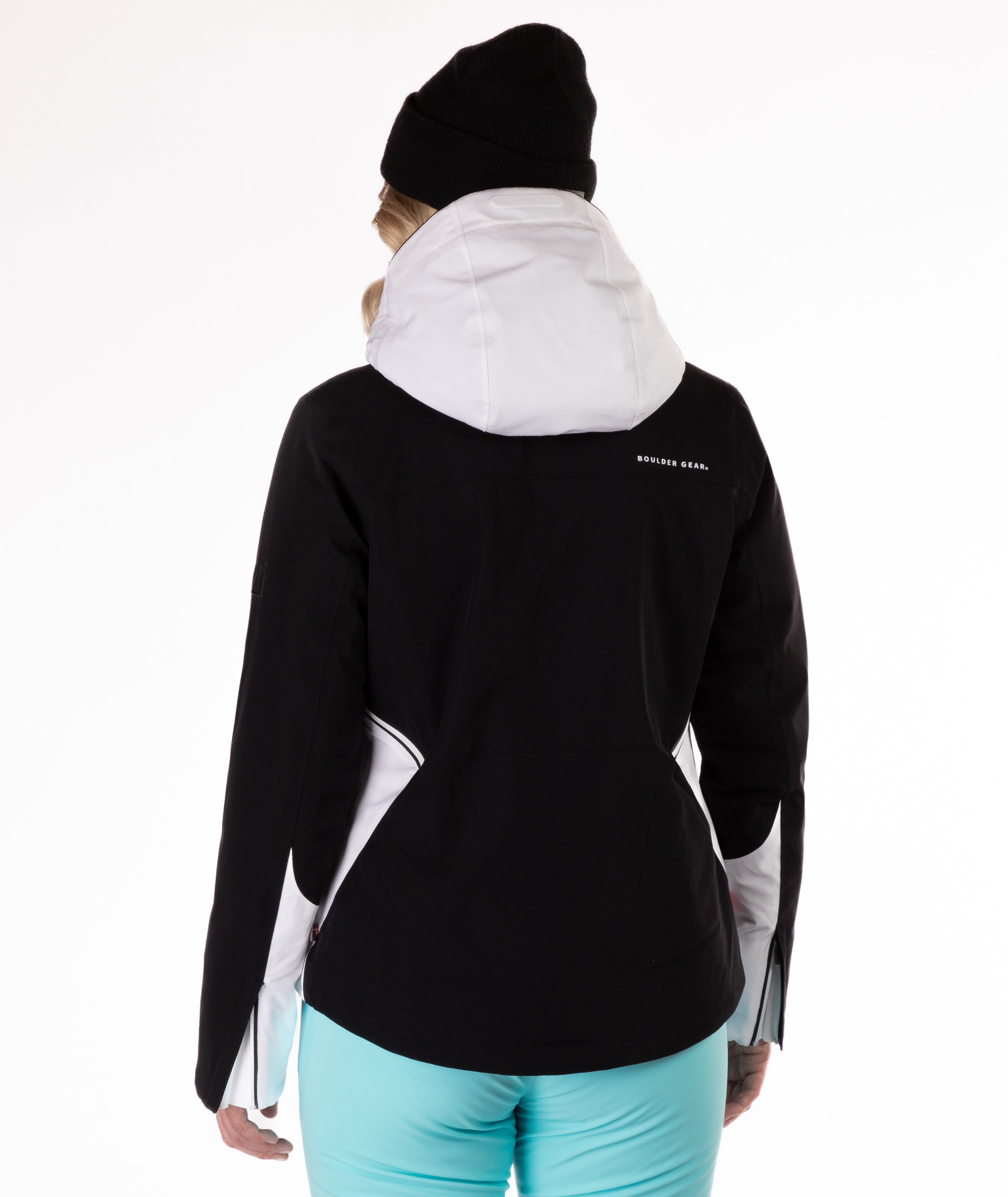 Person wearing a black and white jacket with a hood on a white background