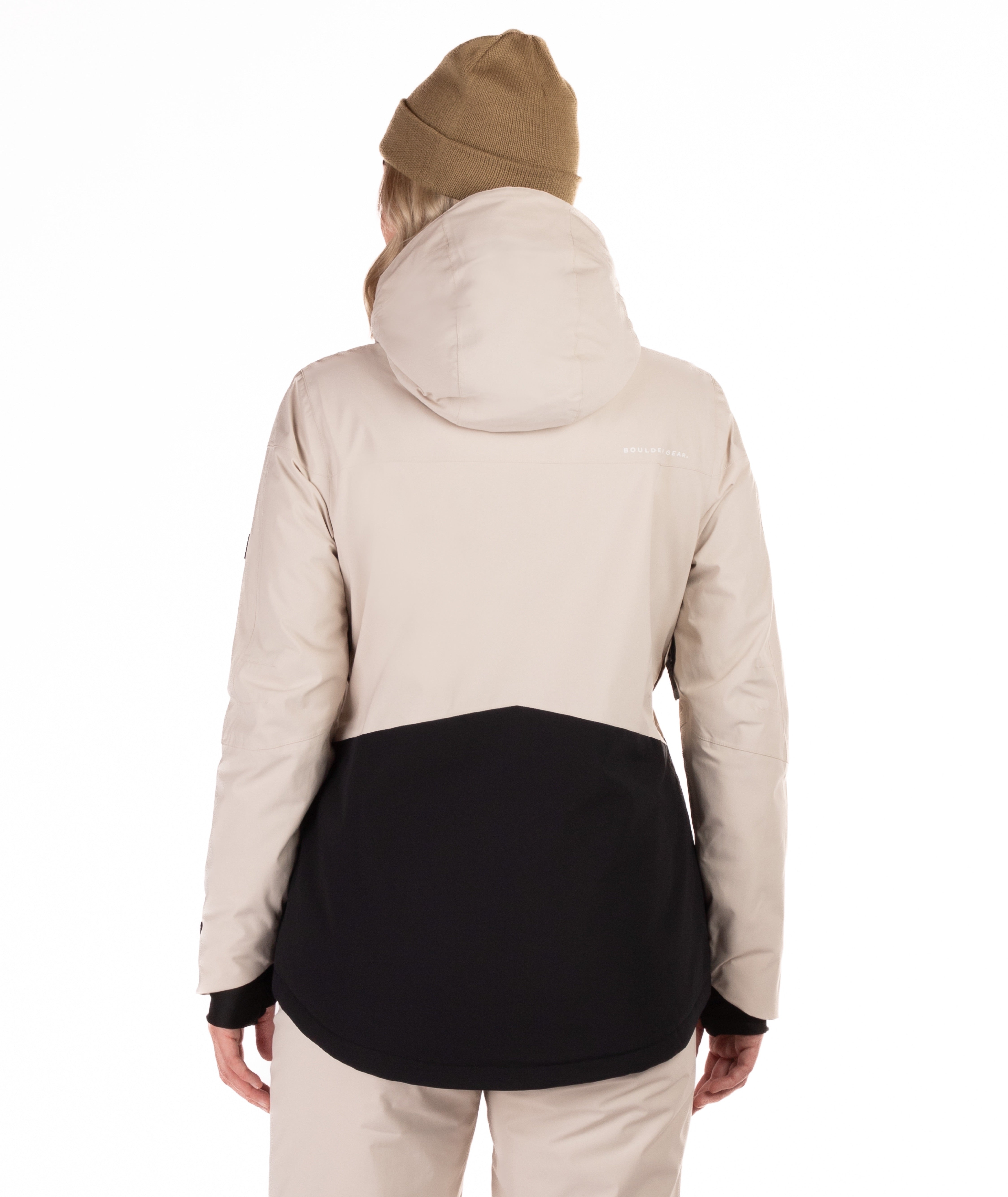 Person wearing a two-tone jacket with beige and black design showing the back view of the jacket on a white background