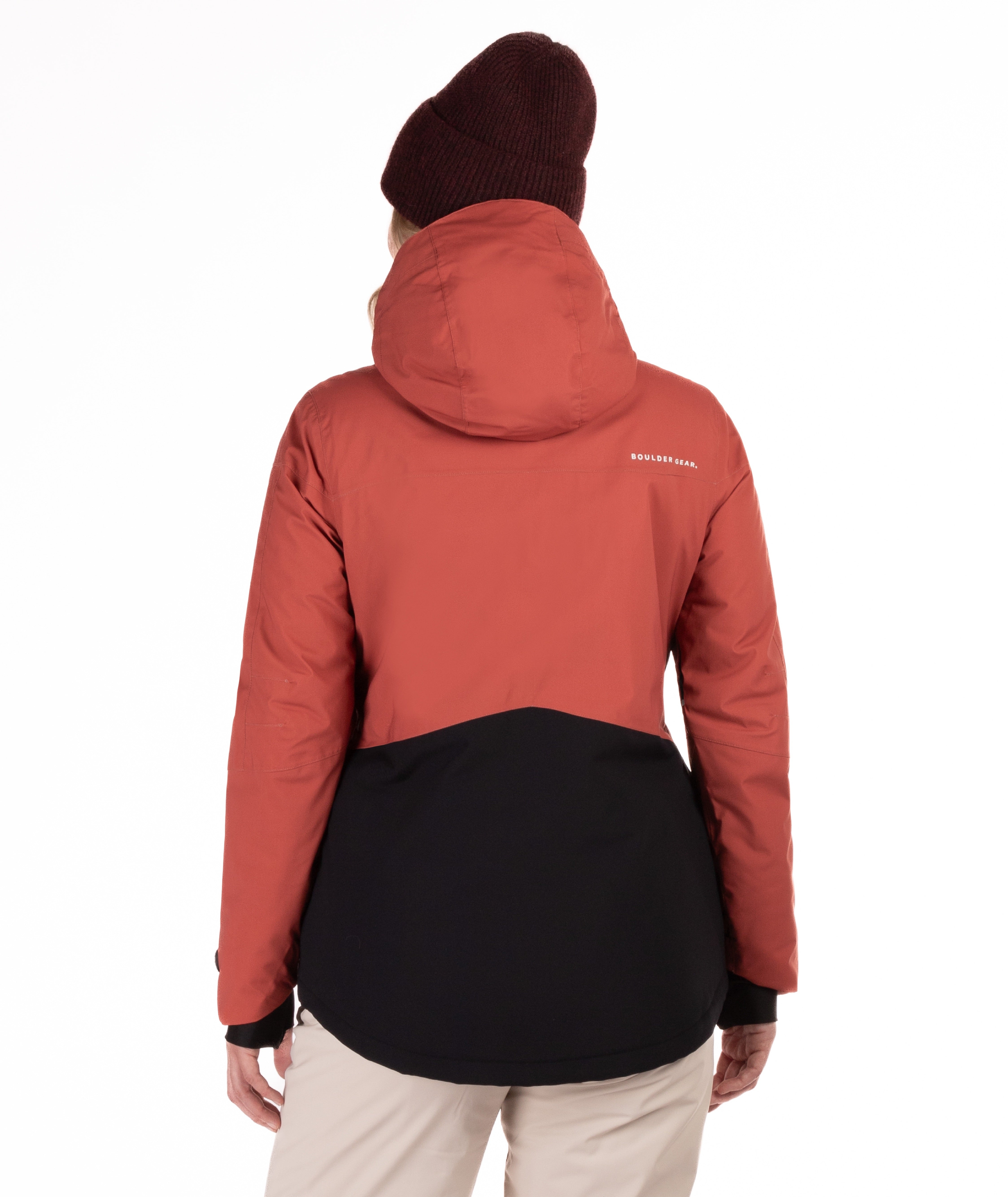 Person wearing a red and black jacket with a visible brand logo on a white background shown from behind