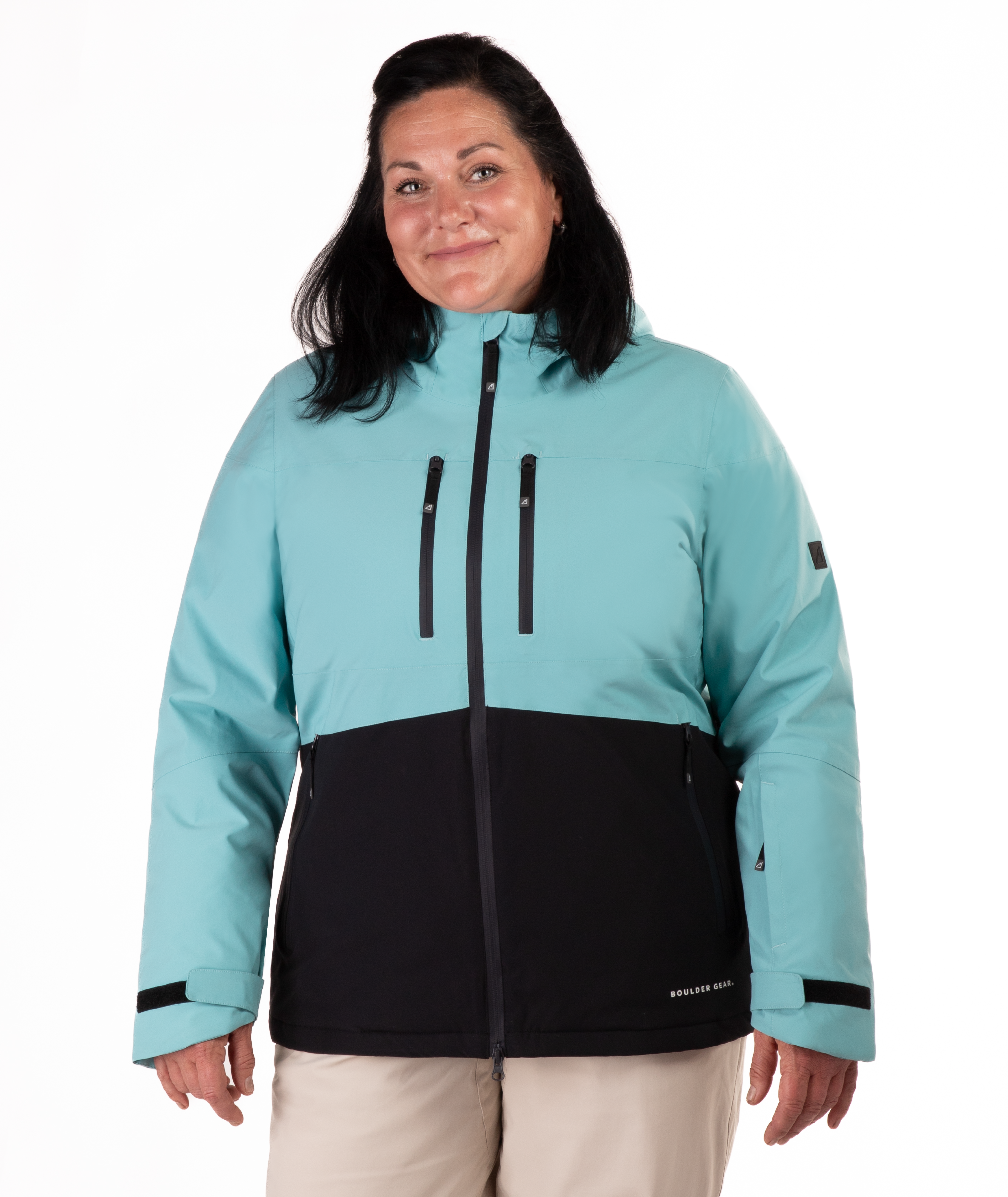 Woman wearing a light blue and black jacket on a white background