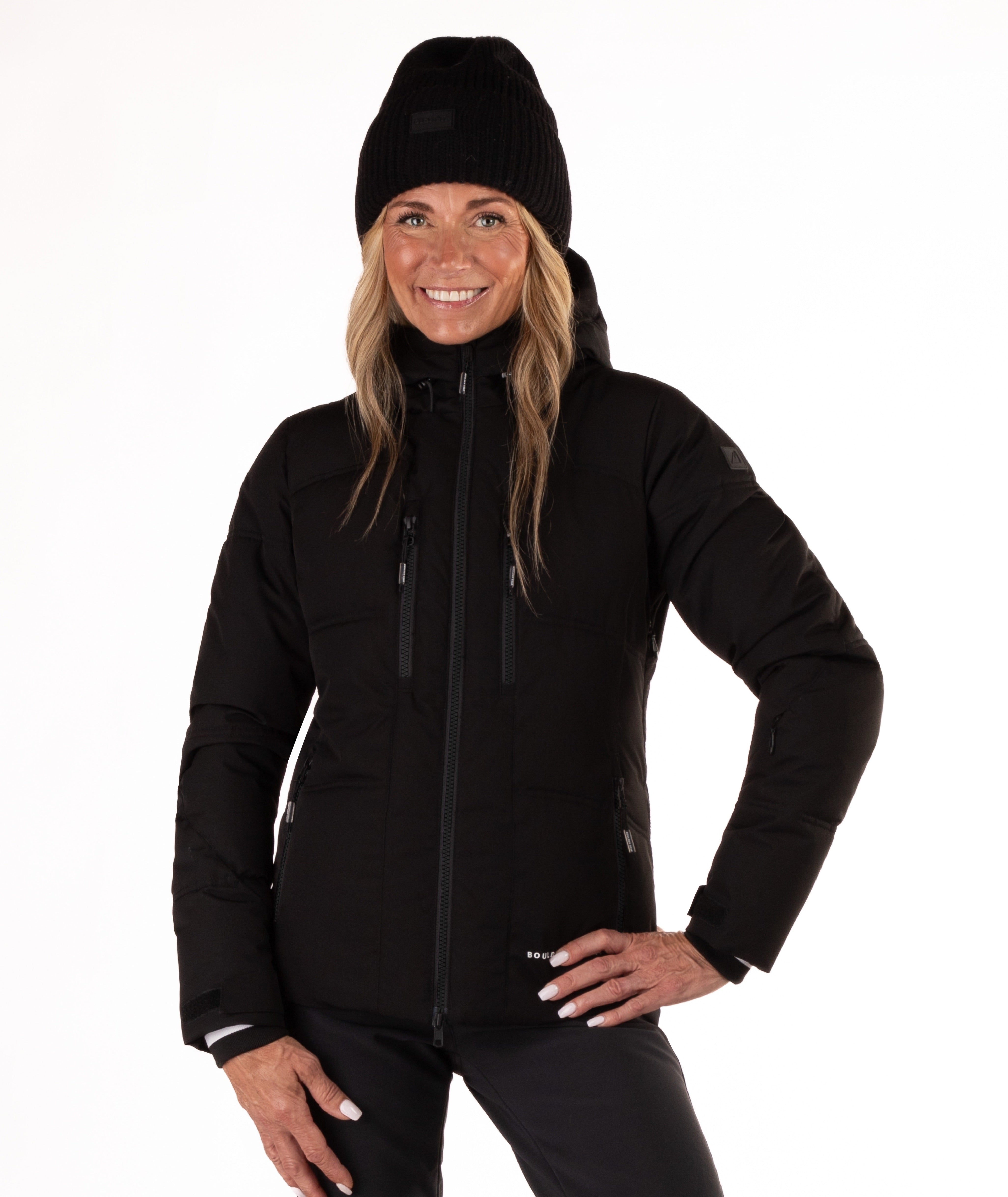 Woman wearing a black quilted winter jacket on a white background