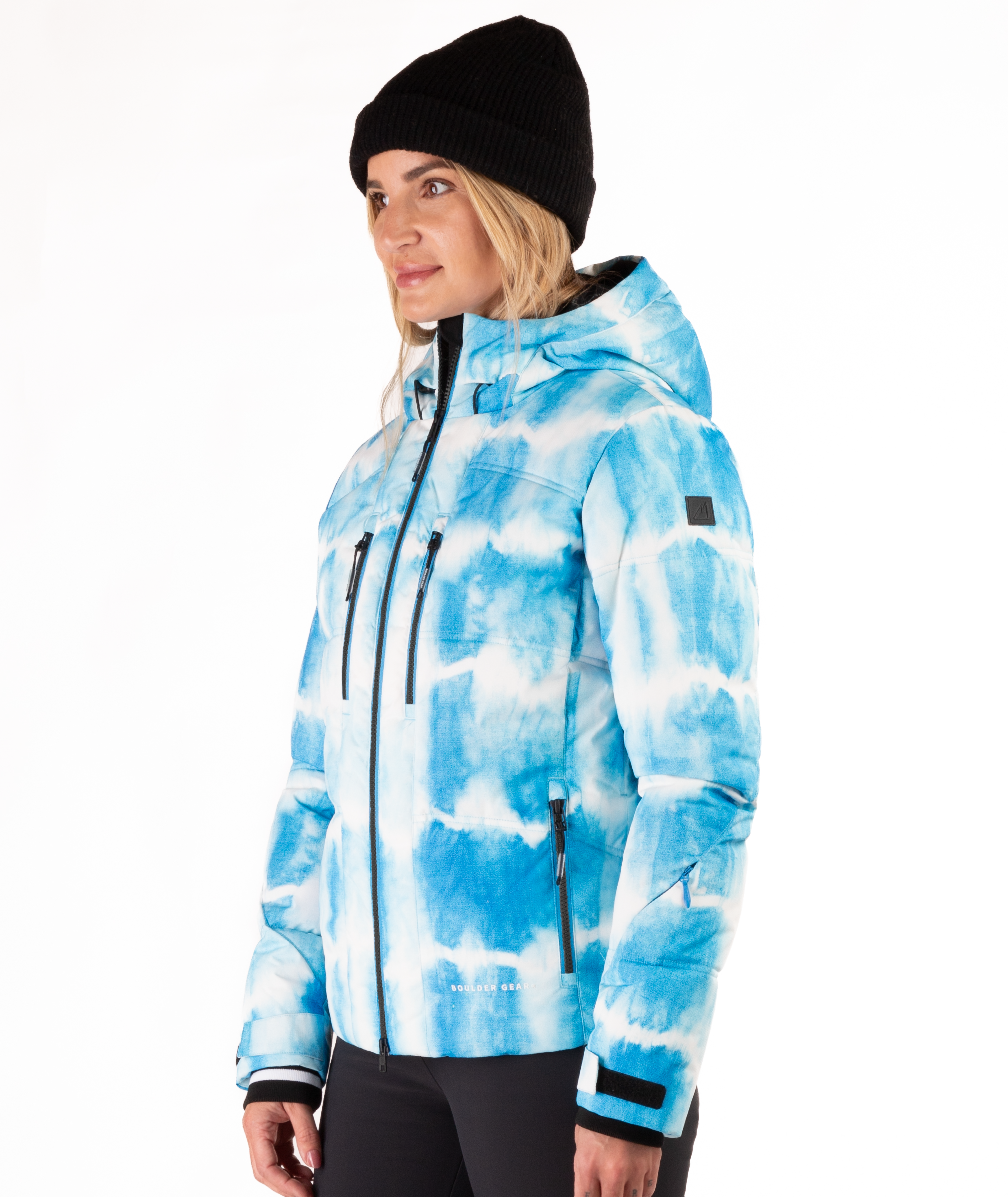 Woman wearing a blue and white tie-died pattern jacket on a white background