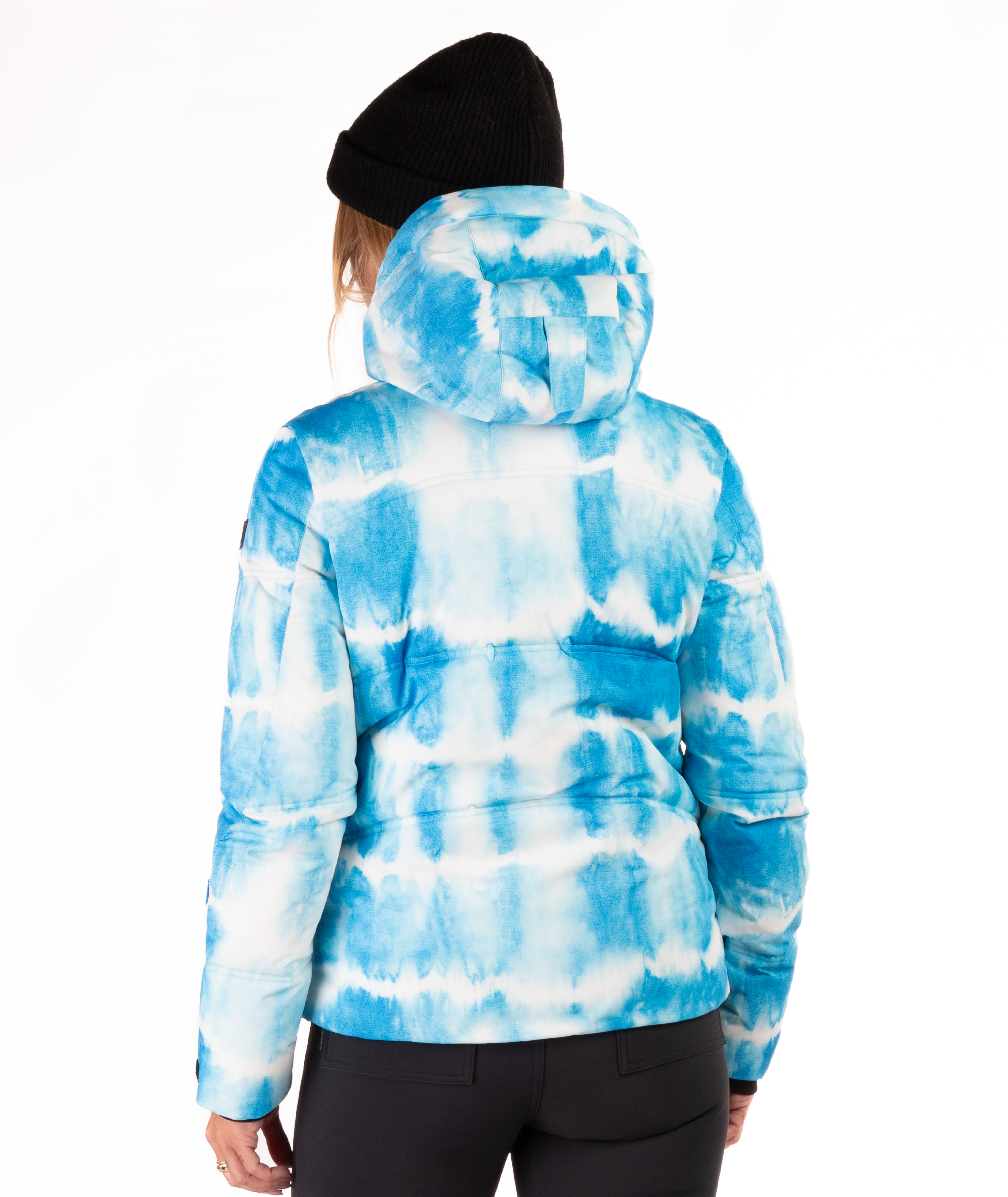 Woman wearing a blue and white tie-died pattern jacket on a white background highlighting the back of the jacket