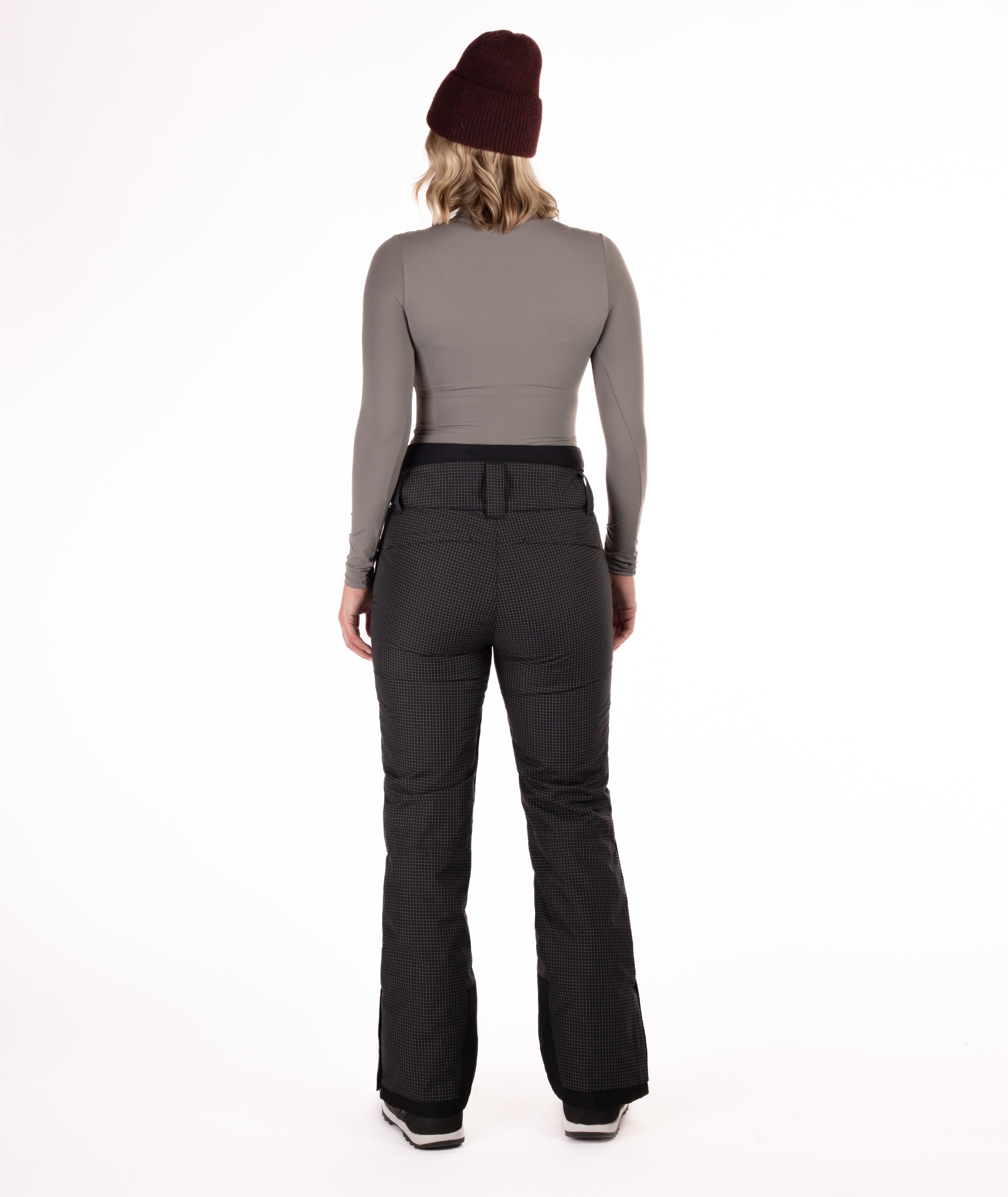 back of Person wearing black rip stop patterned pants with white thread pants on a white background