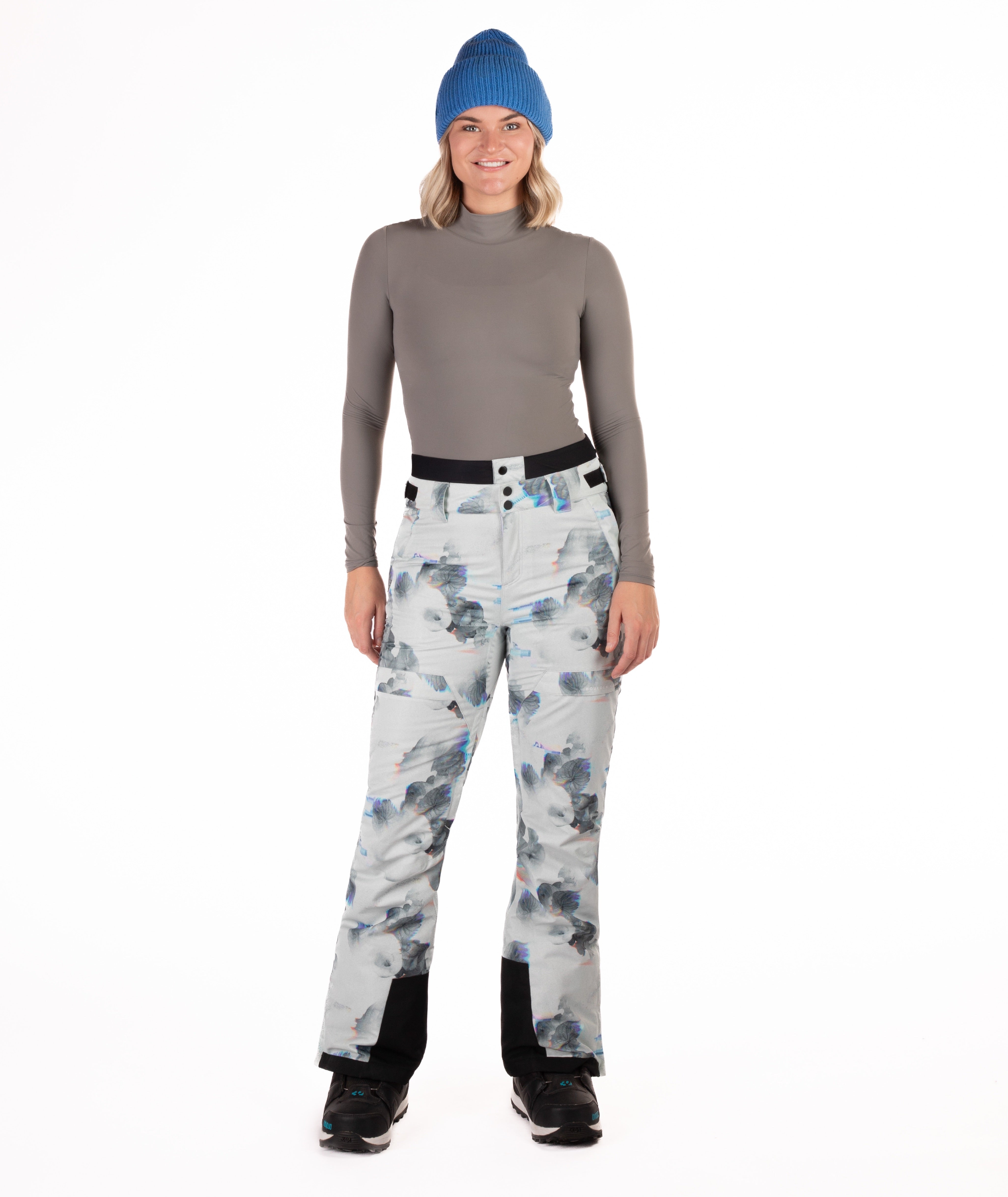 Person wearing floral patterned pants on a white background
