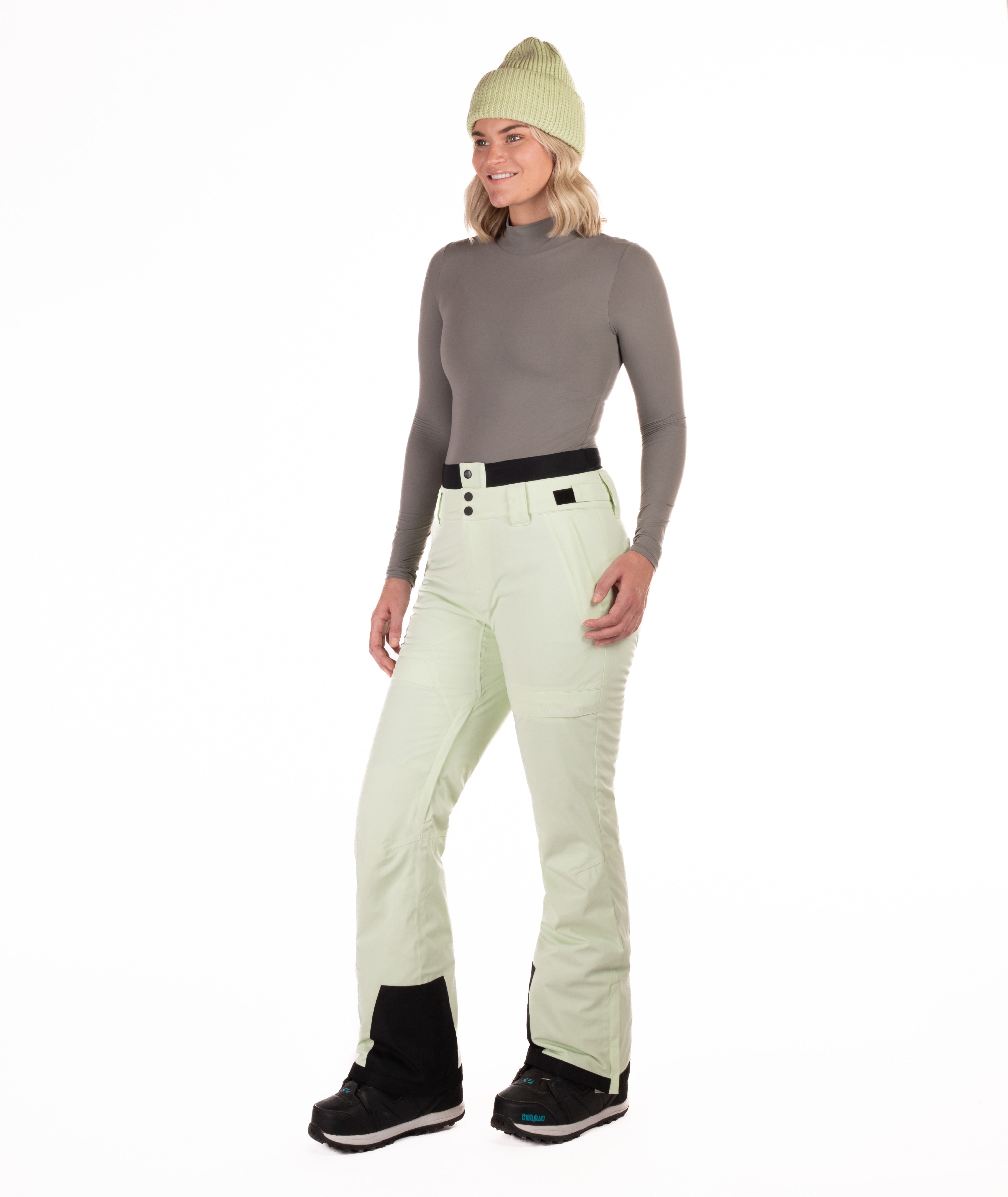 Person wearing light green pants on a white background