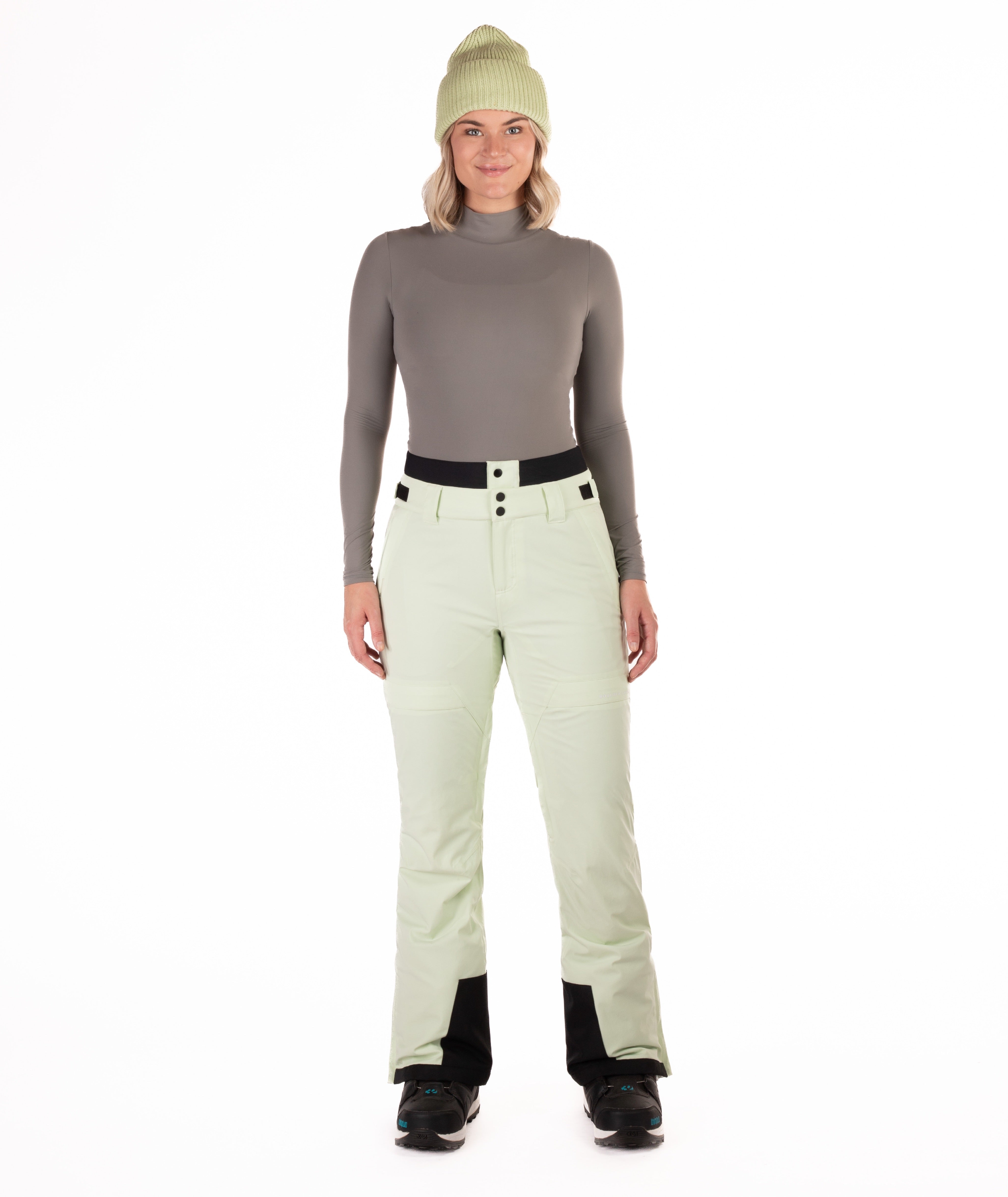 Person wearing light green pants on a white background