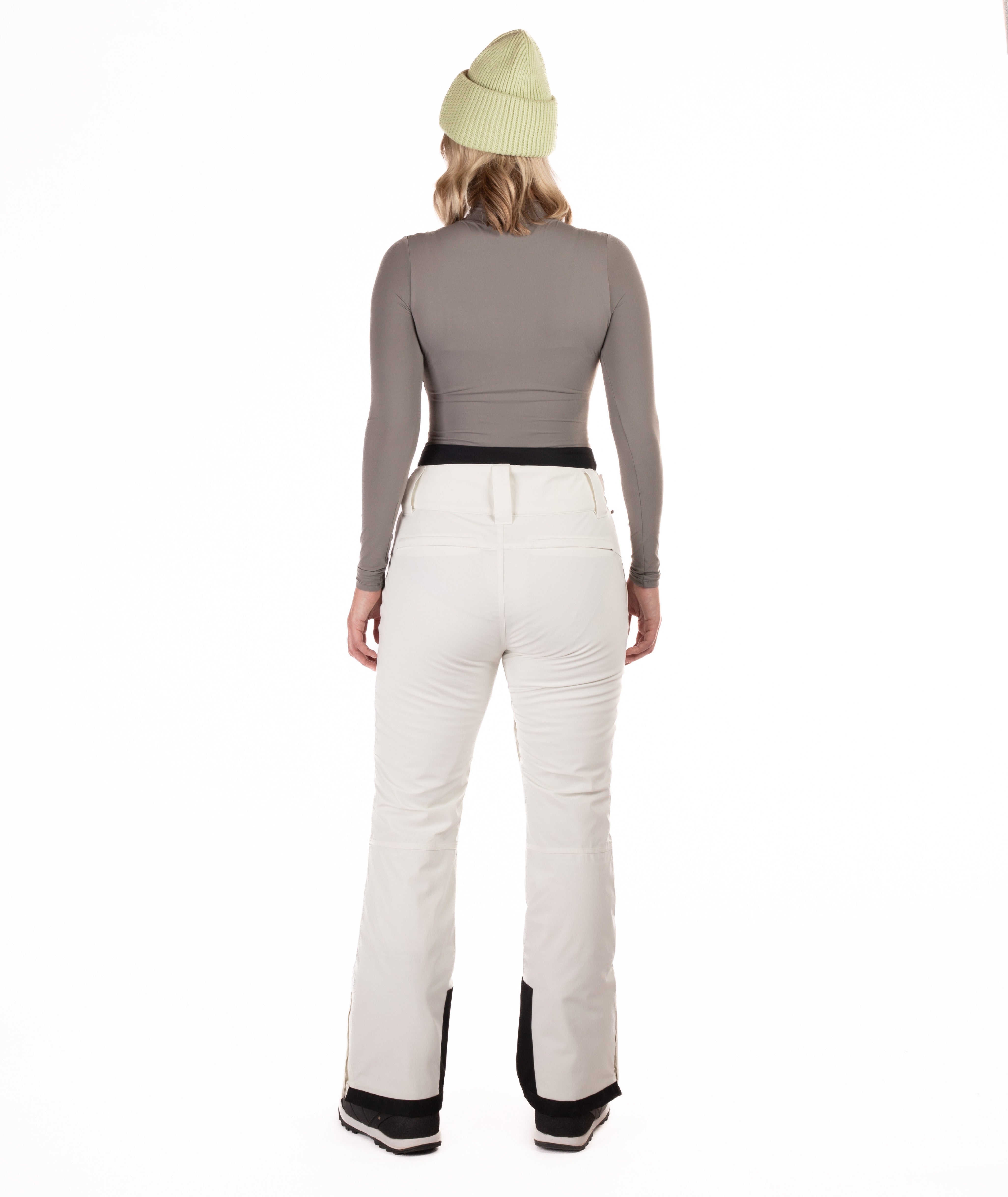 back of Person wearing off white colored pants on a white background