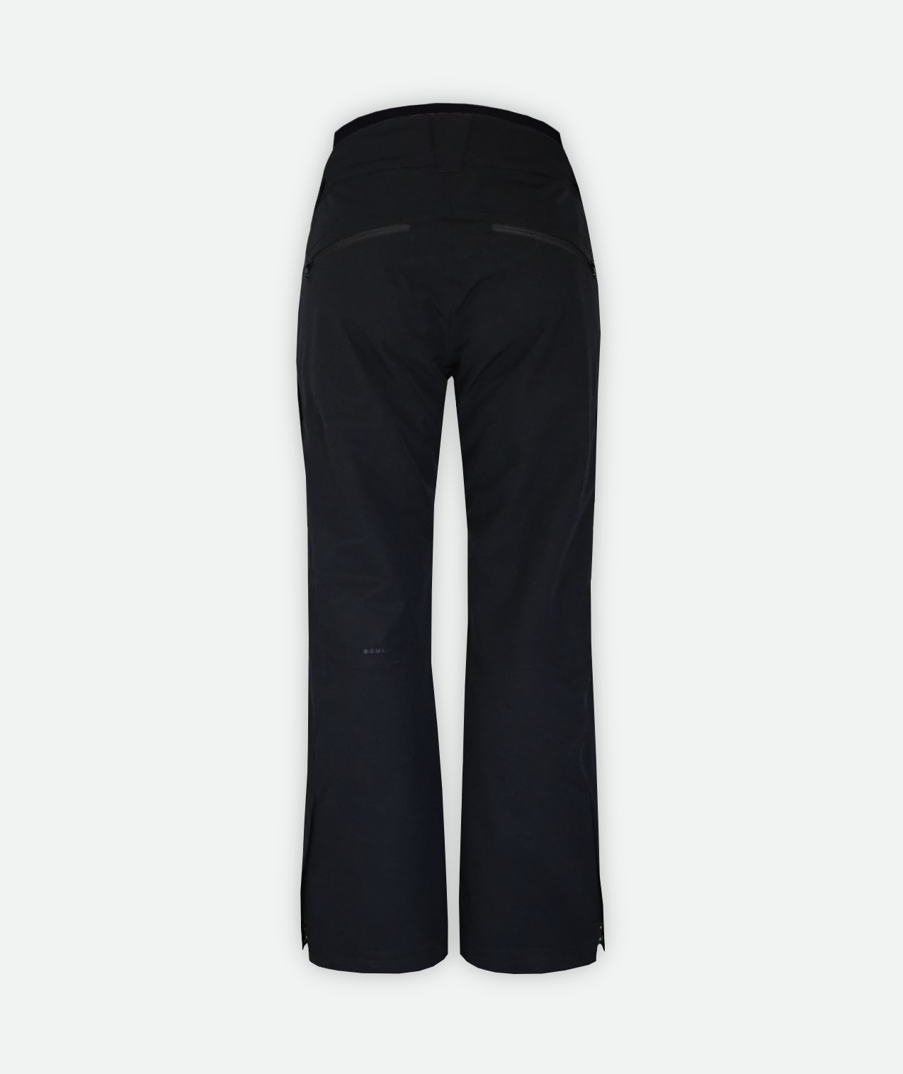 Back view of pair of black ski pants for women with adjustable waistbands and ventilation on a white background.