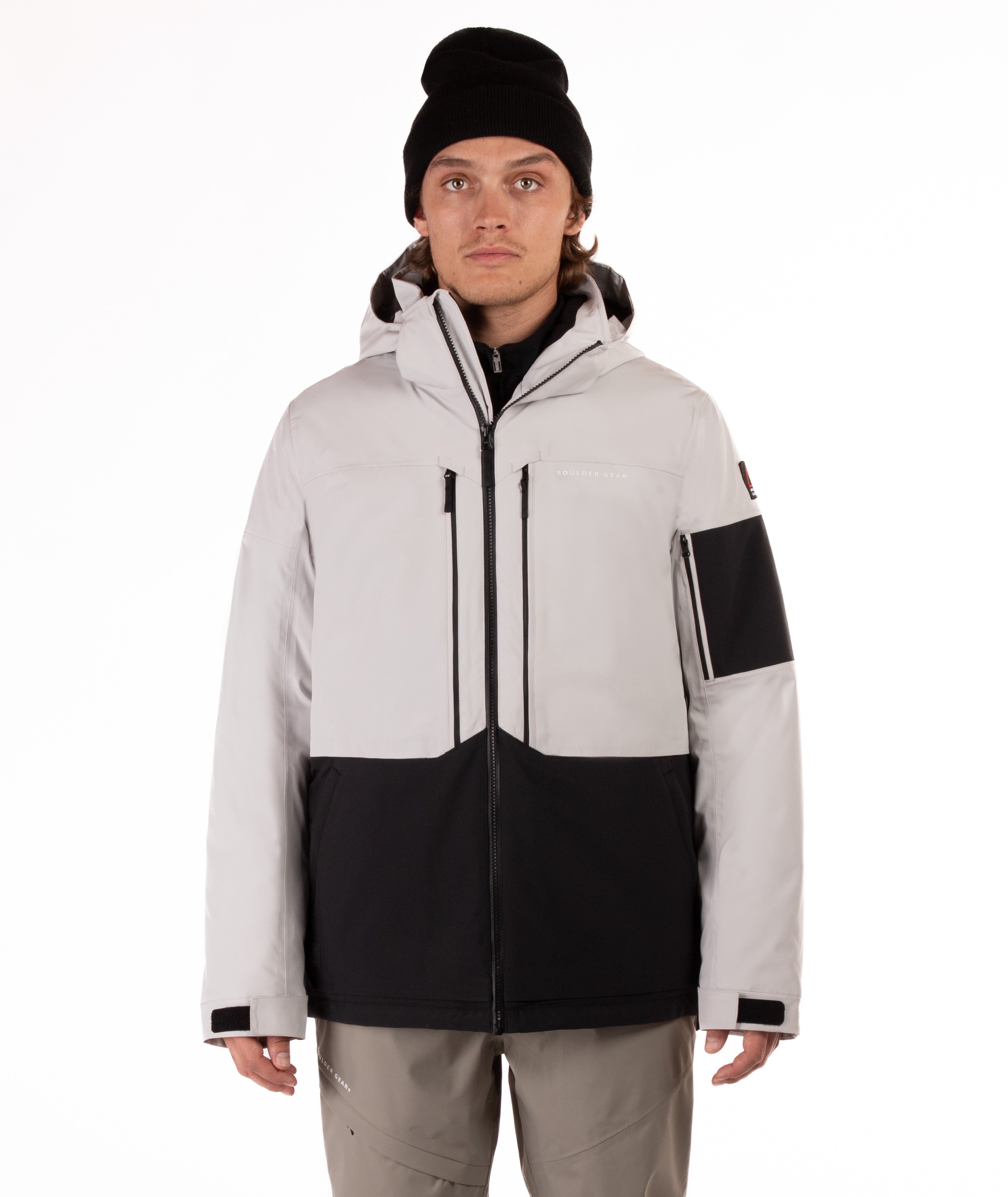 Person wearing a gray and black jacket with a white background