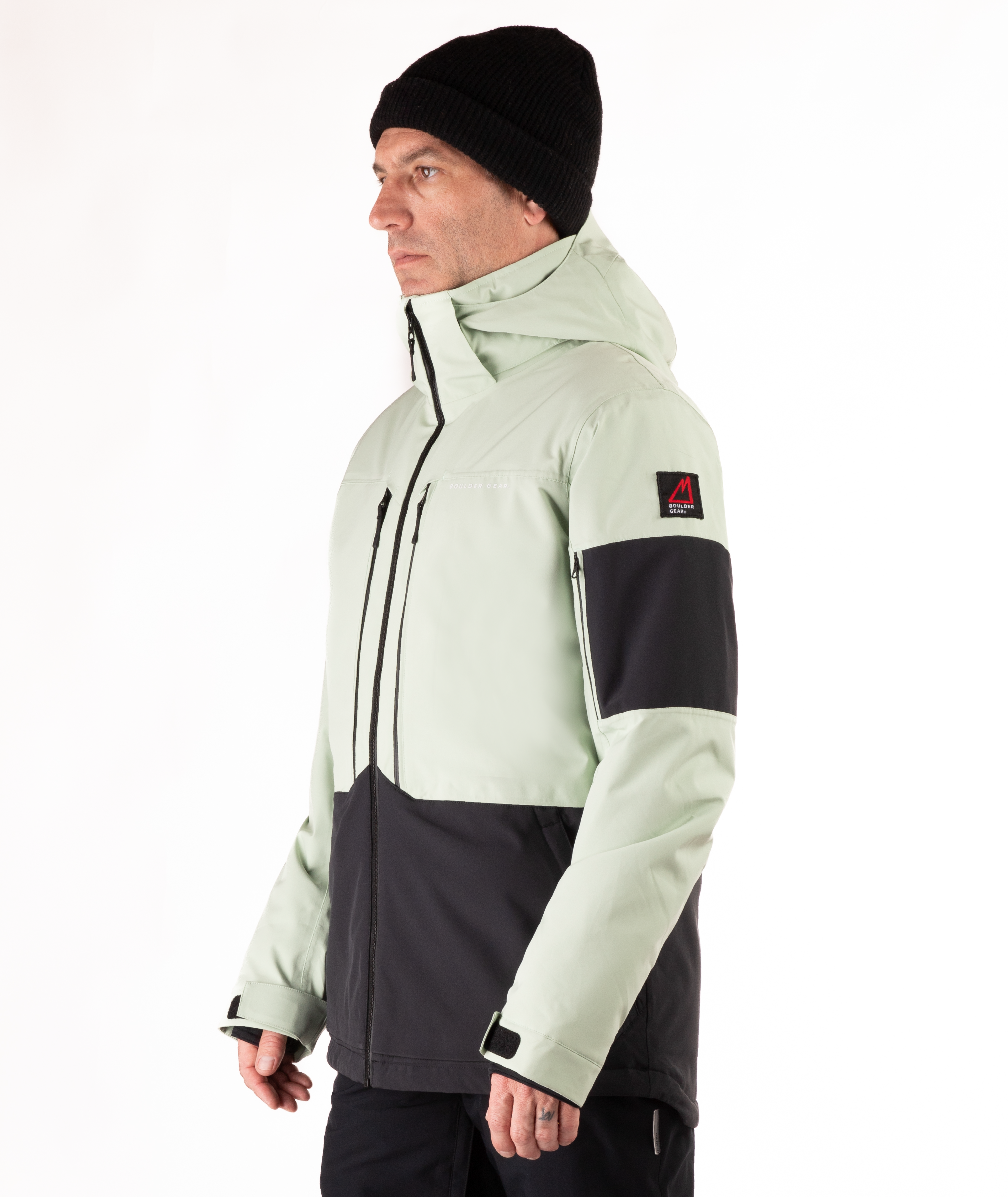 Person wearing a light green and black jacket on a white background