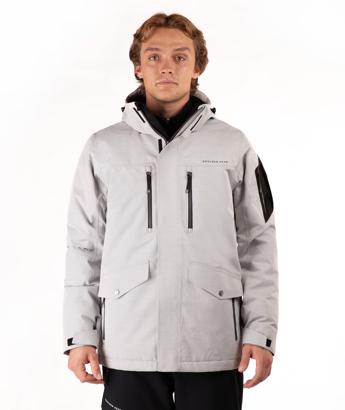 Man wearing a light gray jacket with black accents on a white background