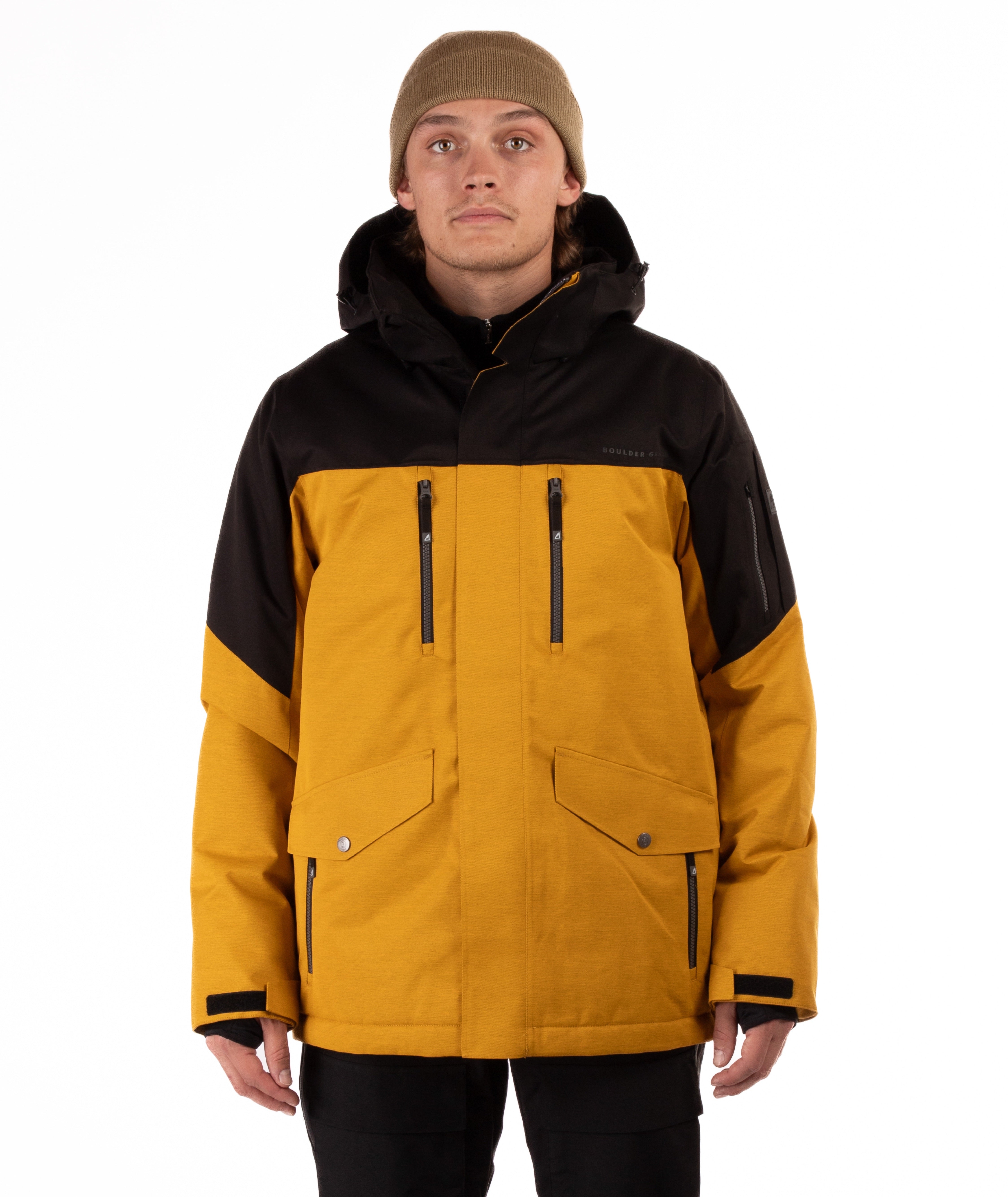 Person wearing a mustard yellow and black jacket on a white background