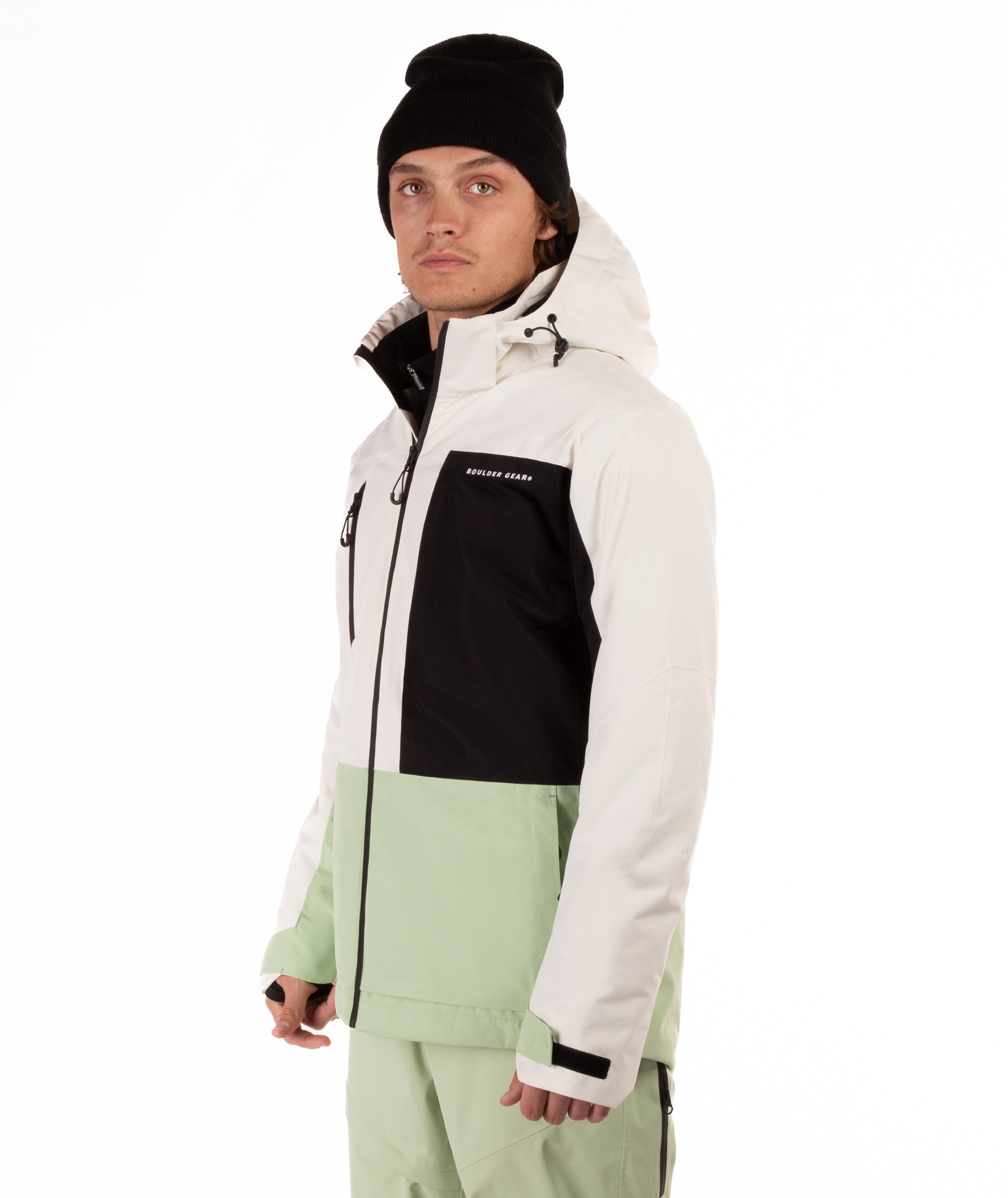 Person wearing a white, black, and green jacket on a white background
