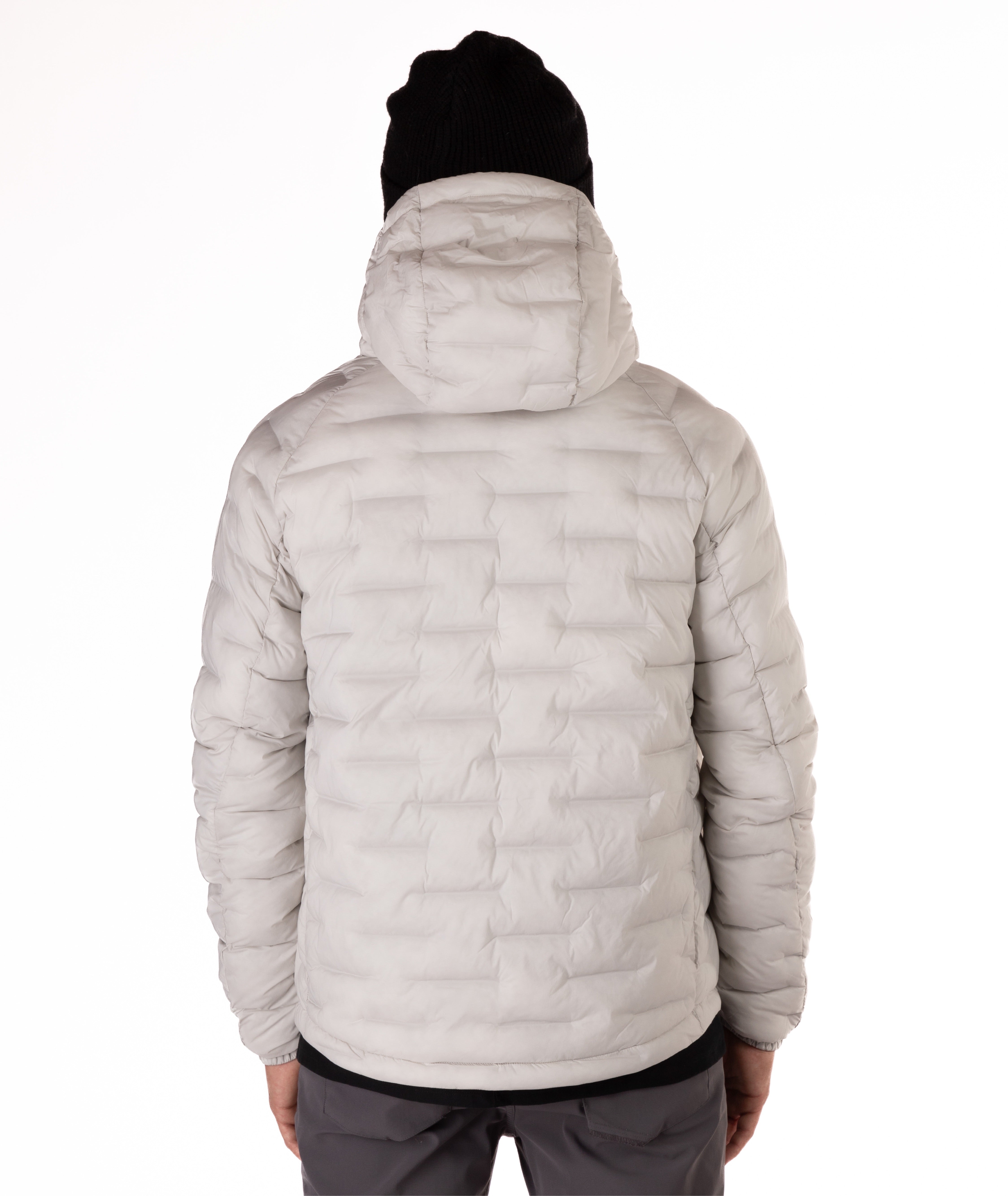 Light gray puffer jacket worn by a person on a white background
