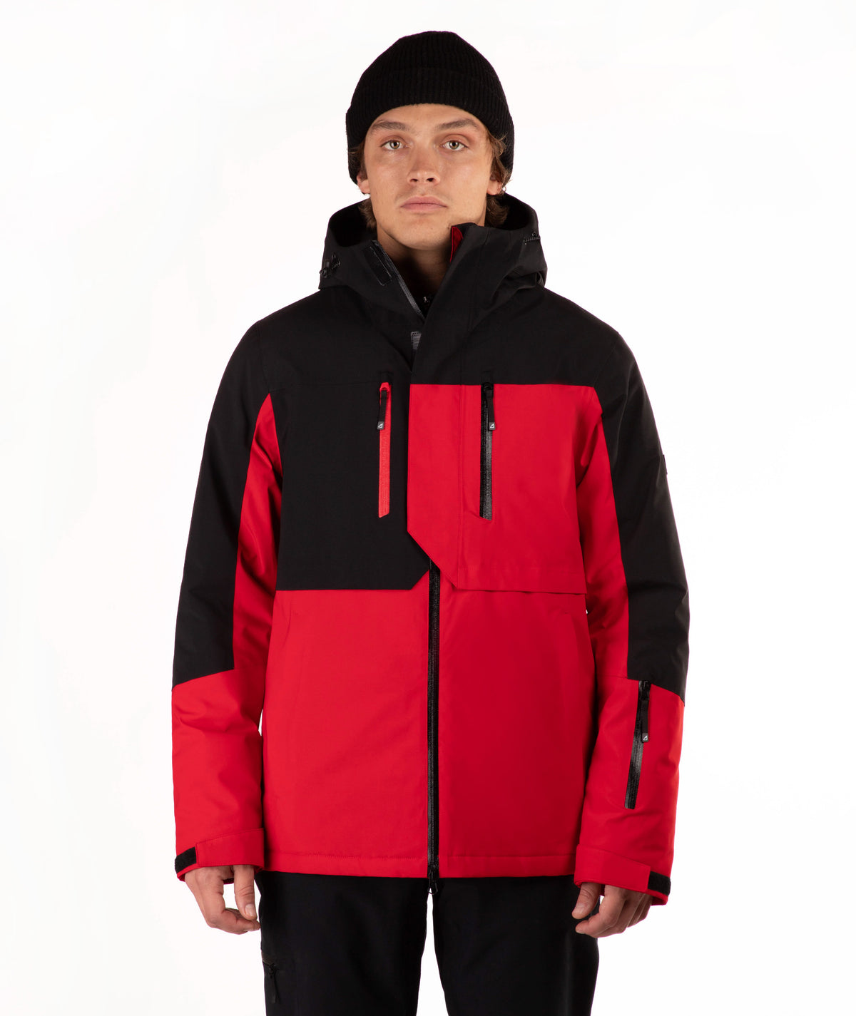 A model wearing a red and black color-blocked ski jacket with a black beanie, photographed against a clean white studio background.