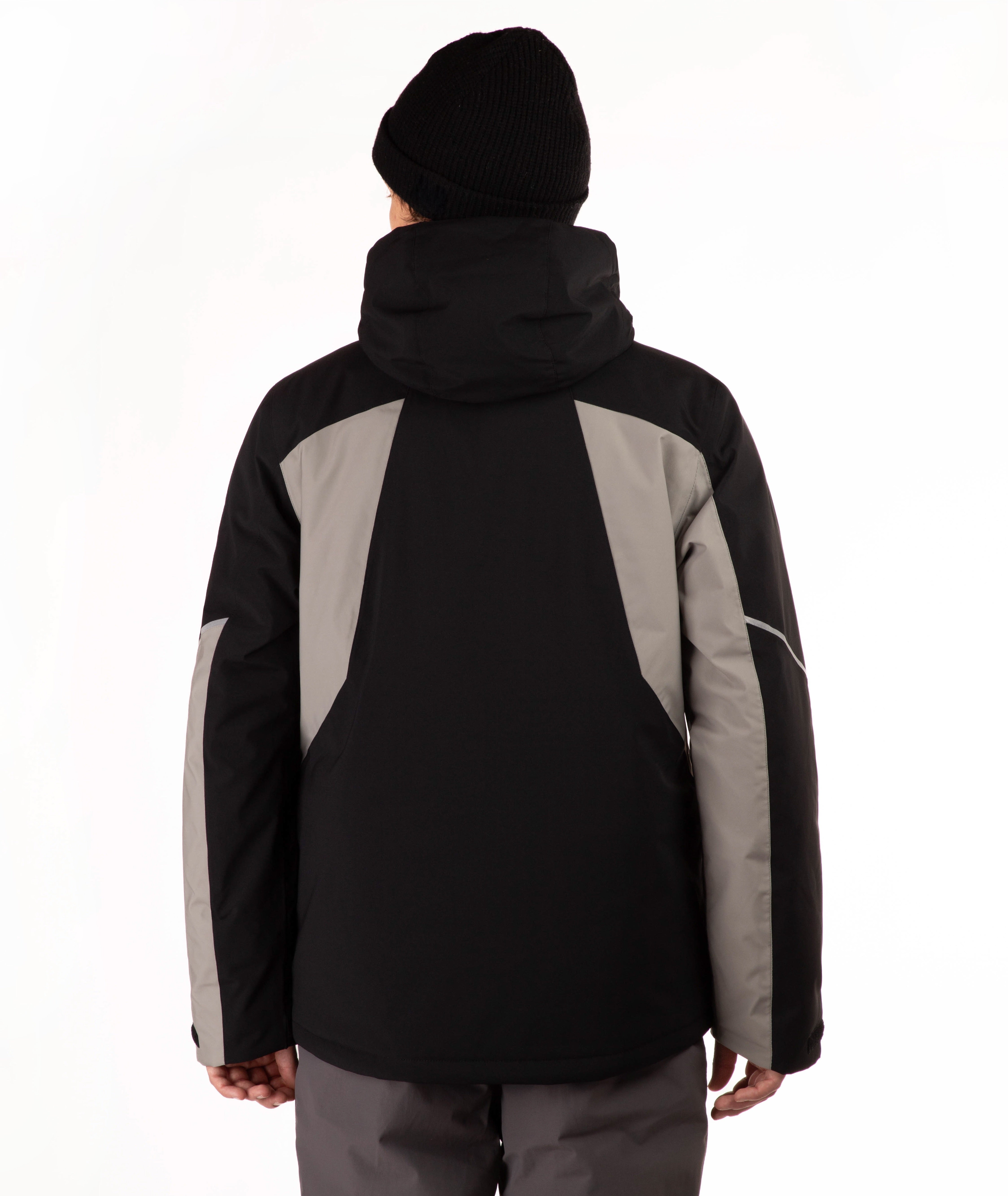 A person shown from the back wearing a black and gray hooded jacket, a black beanie, and gray pants against a plain white studio background.