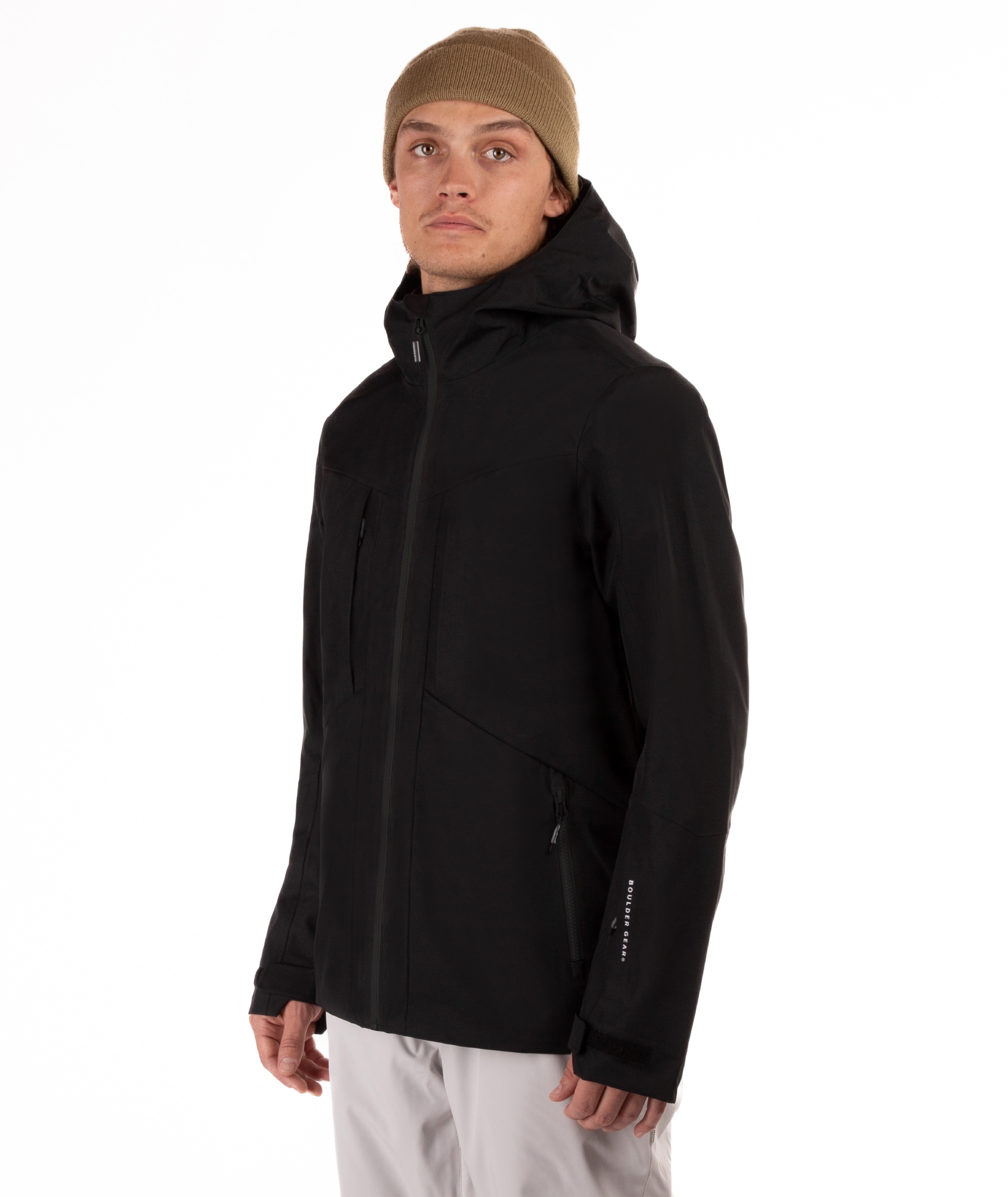 Person wearing a black jacket with black accents on a white background