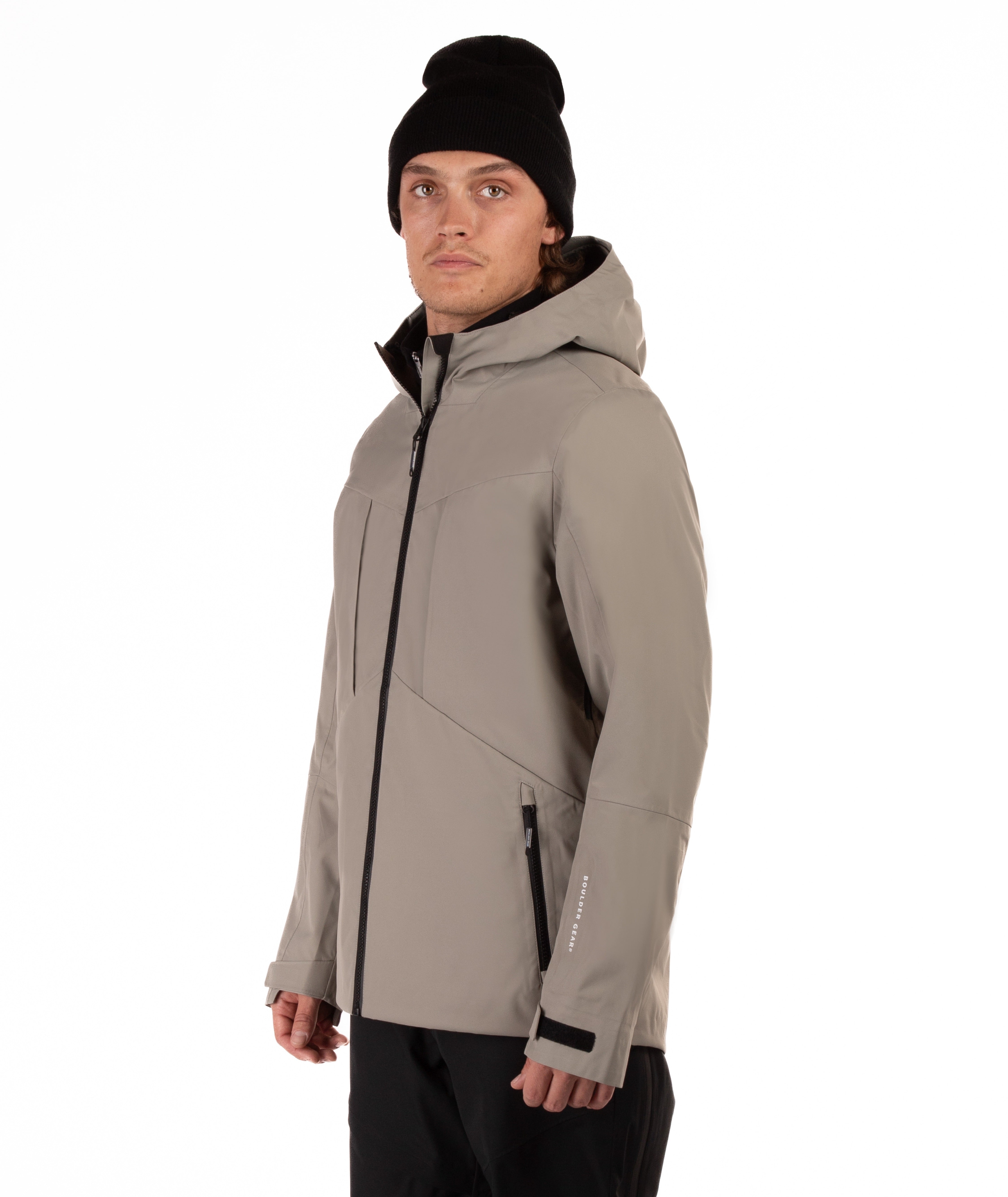 Man wearing a beige jacket with black accents on a white background