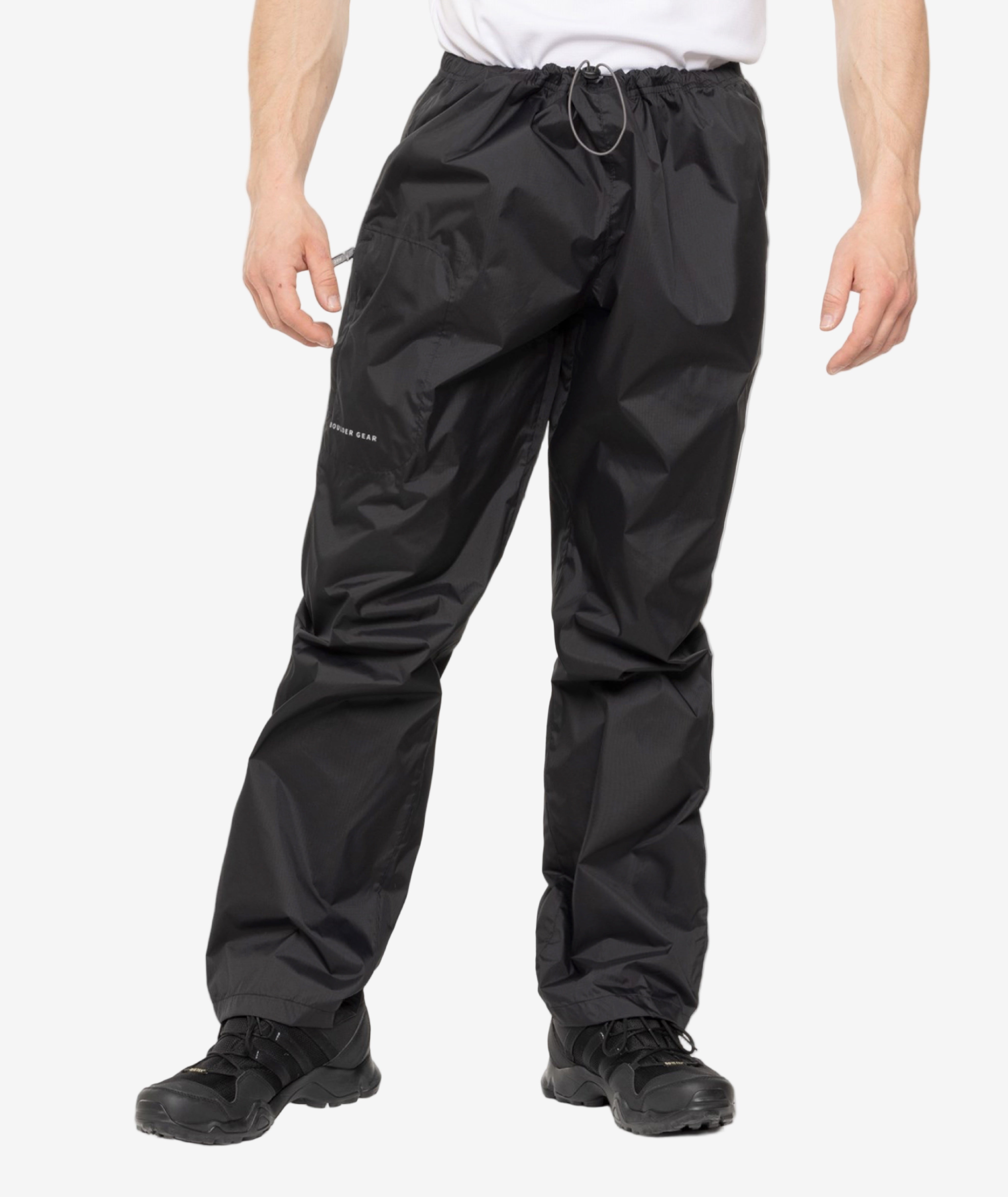 Black rain pants worn by a person on a white background