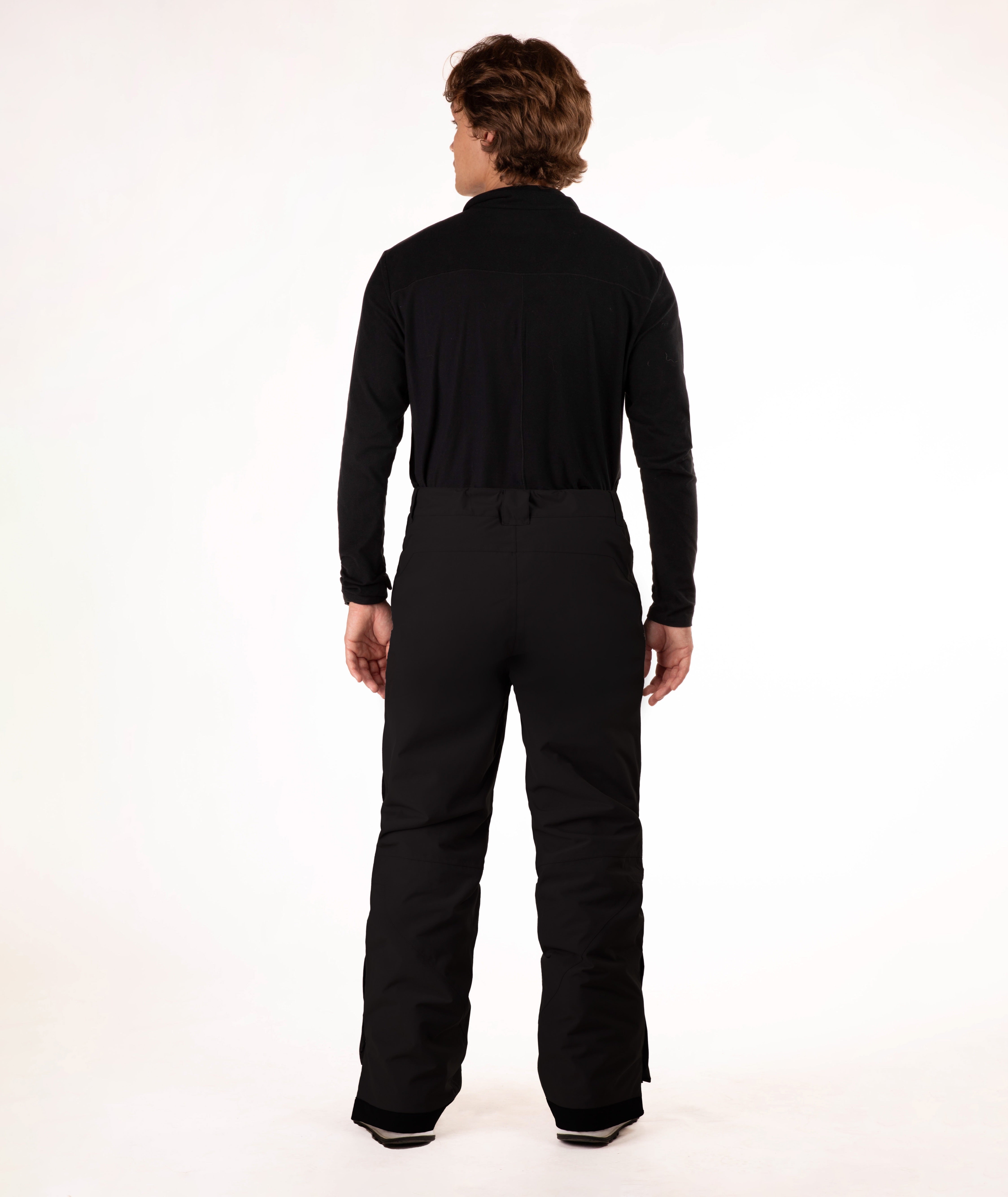Person wearing a black outfit on a white background