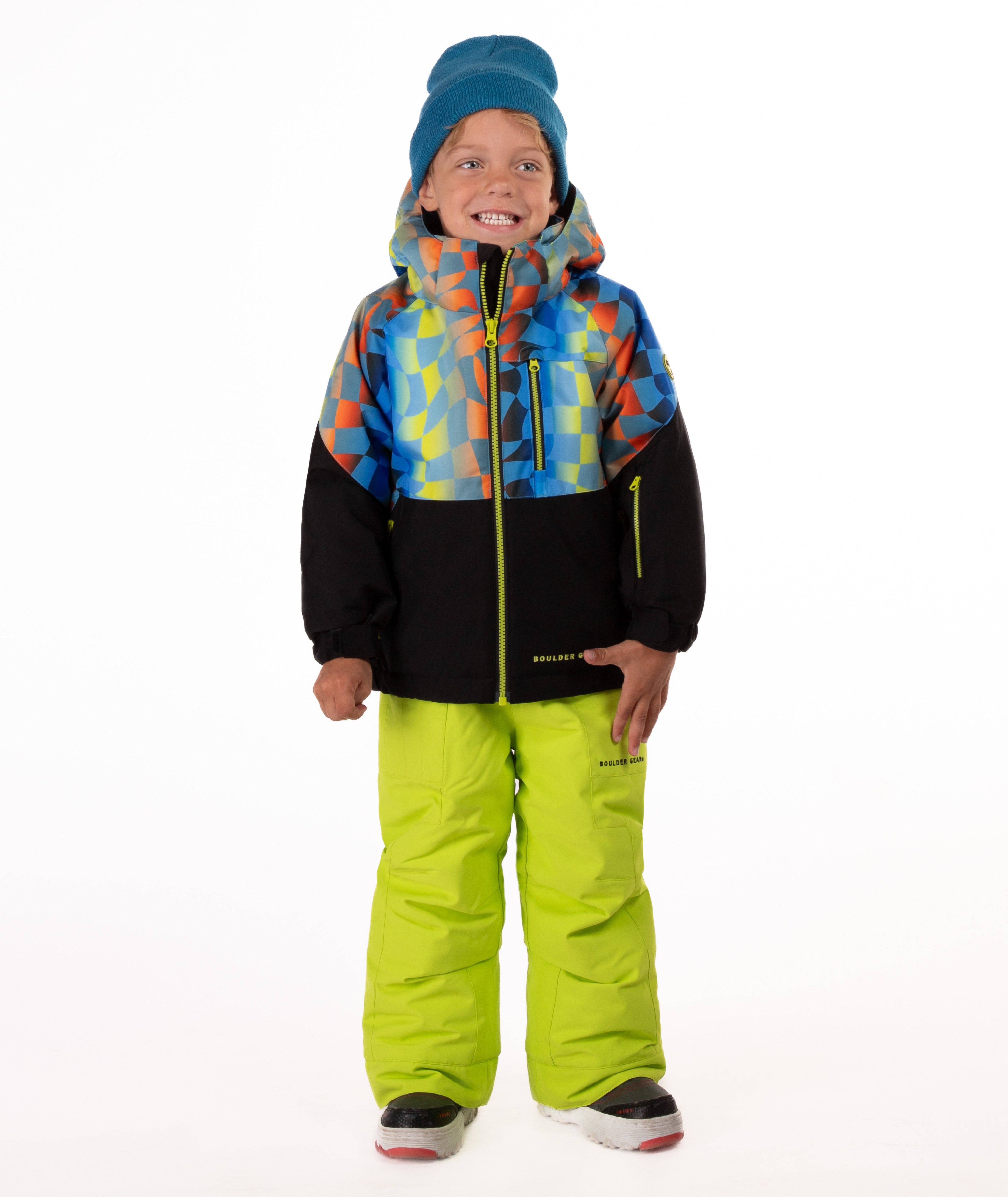 Child wearing a two-tone jacket with a geometric multi-color print on the top and black on the bottom of the jacket