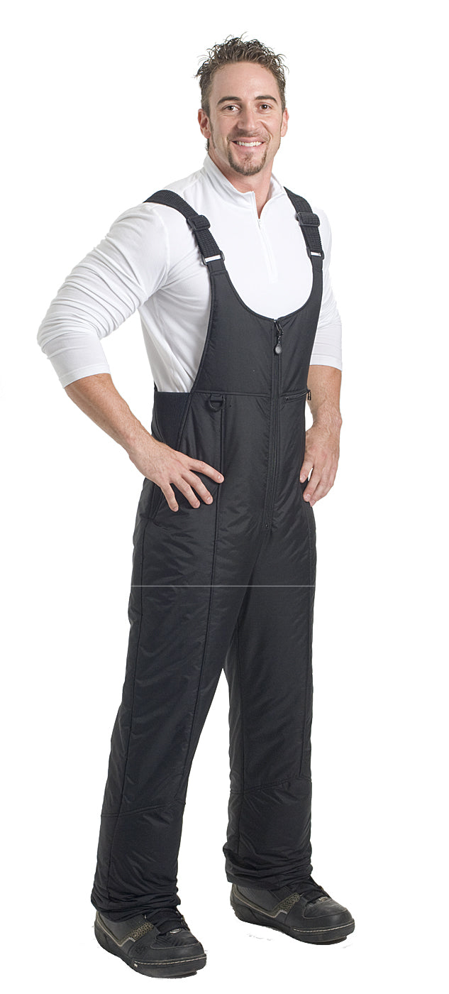 A man wearing black snow bib with adjustable shoulder straps on a white background