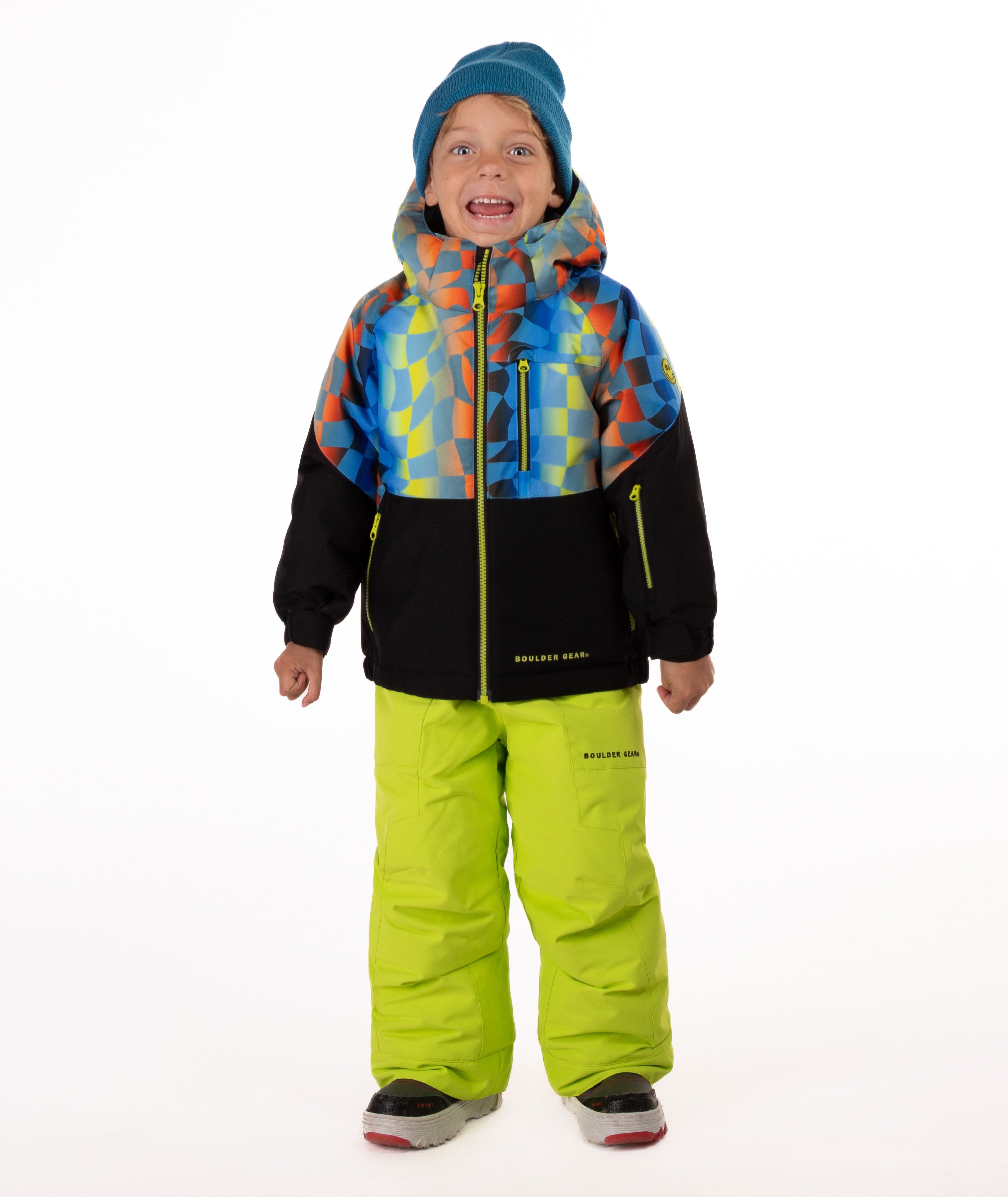 Child wearing a two-tone jacket with a geometric multi-color print on the top and black on the bottom of the jacket