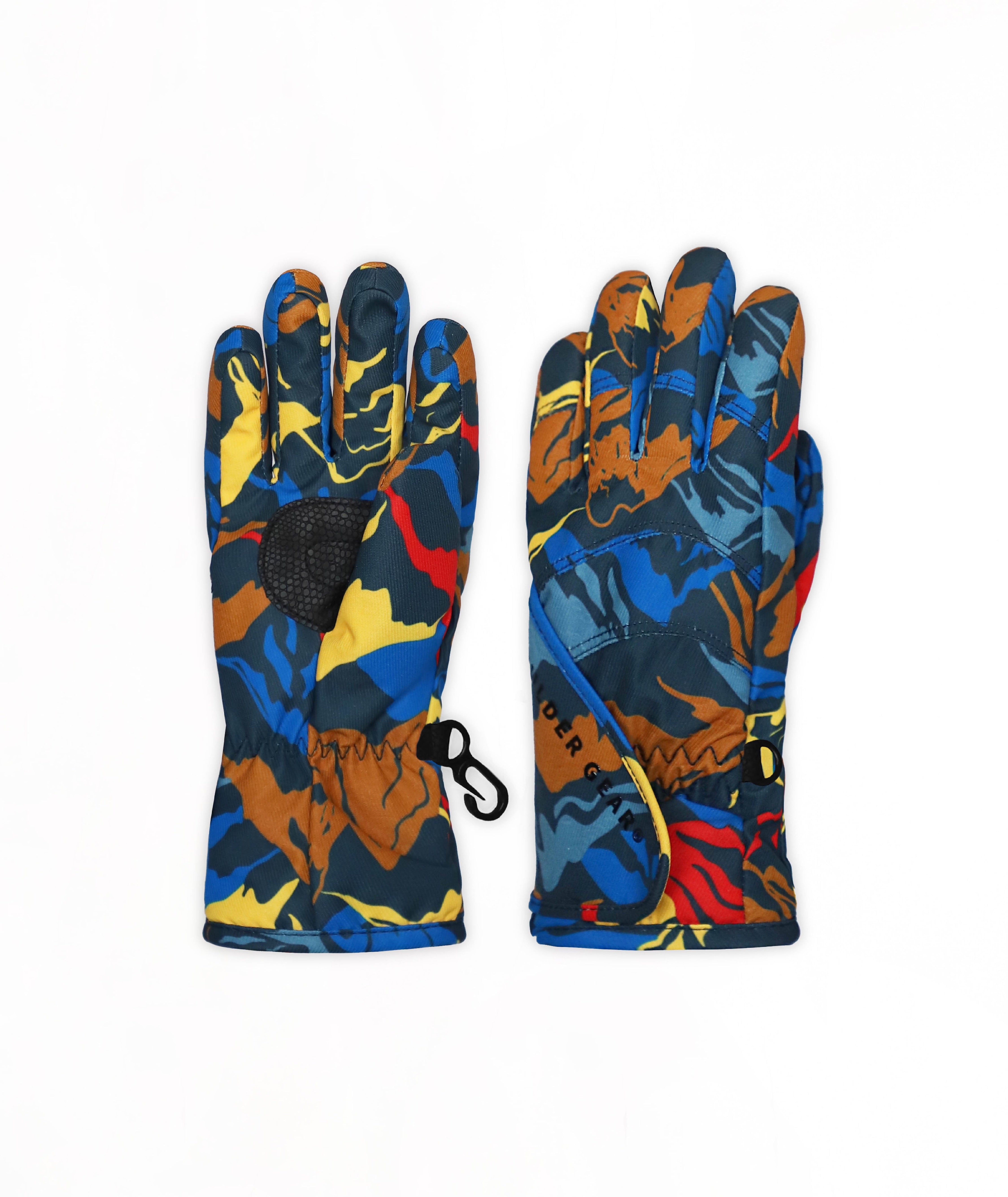A pair of multicolor mountain pattern ski gloves with a black grip patch and a small black carabiner, shown against a plain white background.