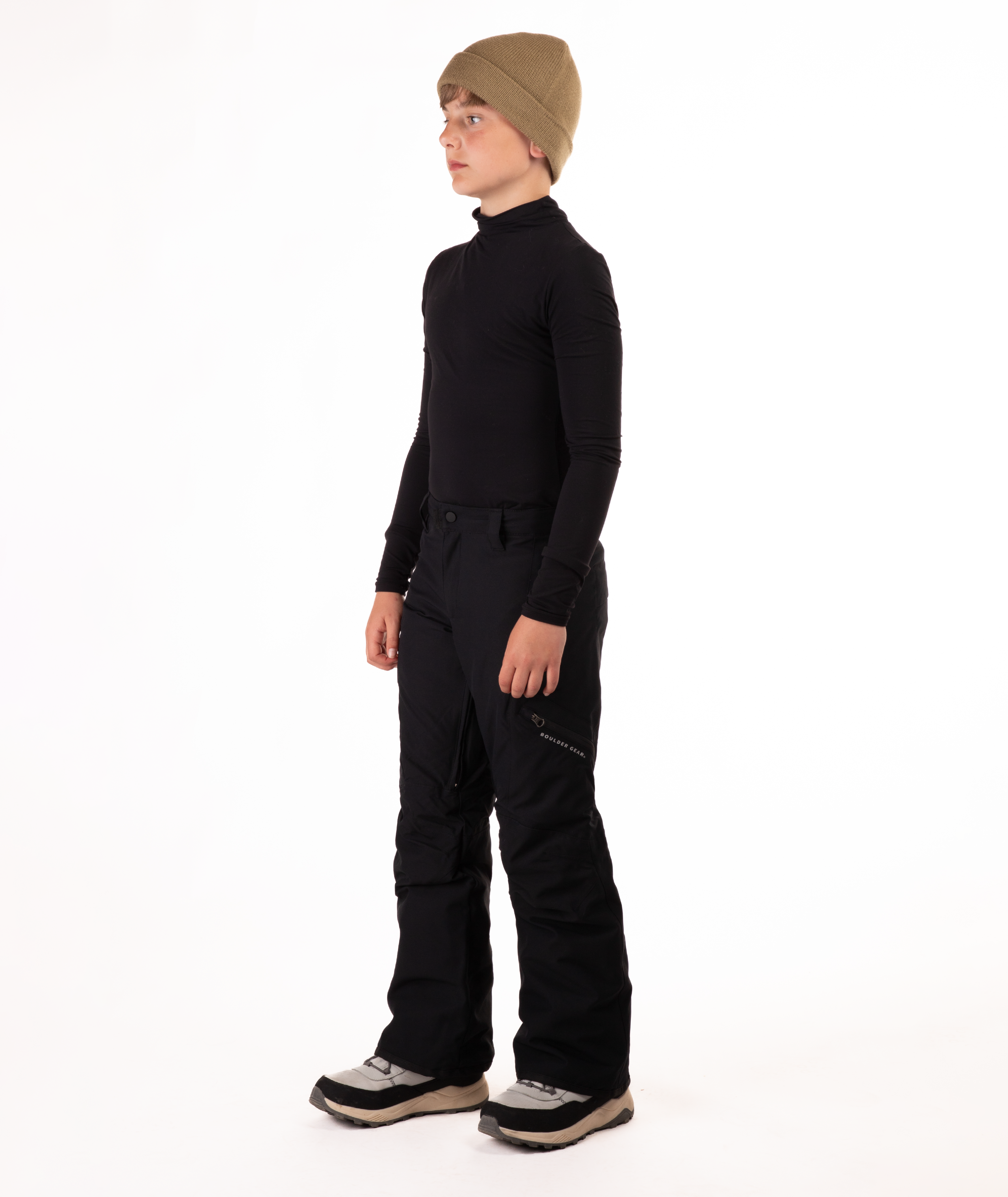 youth boy wearing a black long-sleeve shirt and black snow pants on a white background