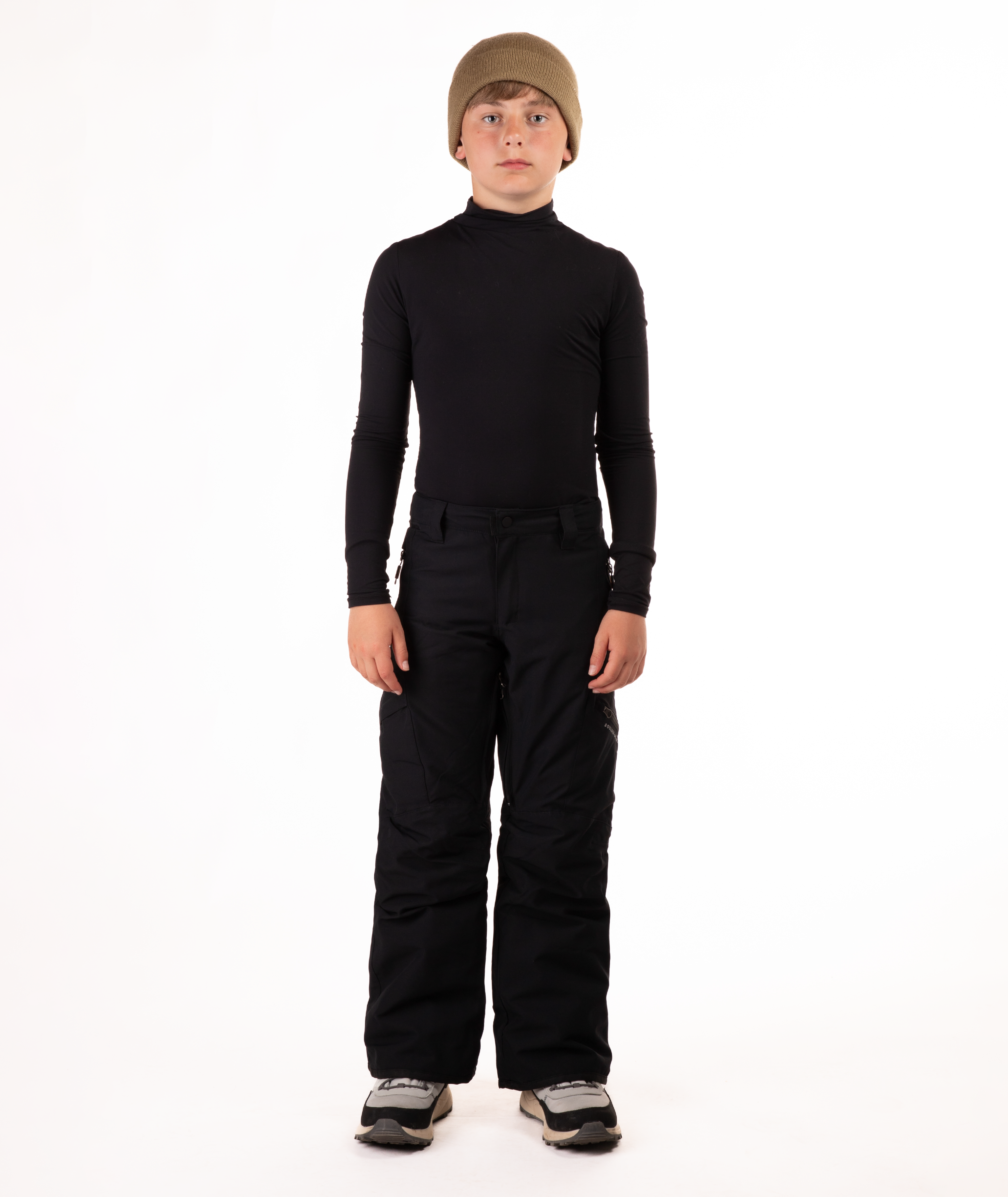 youth boy wearing a black long-sleeve shirt and black snow pants on a white background