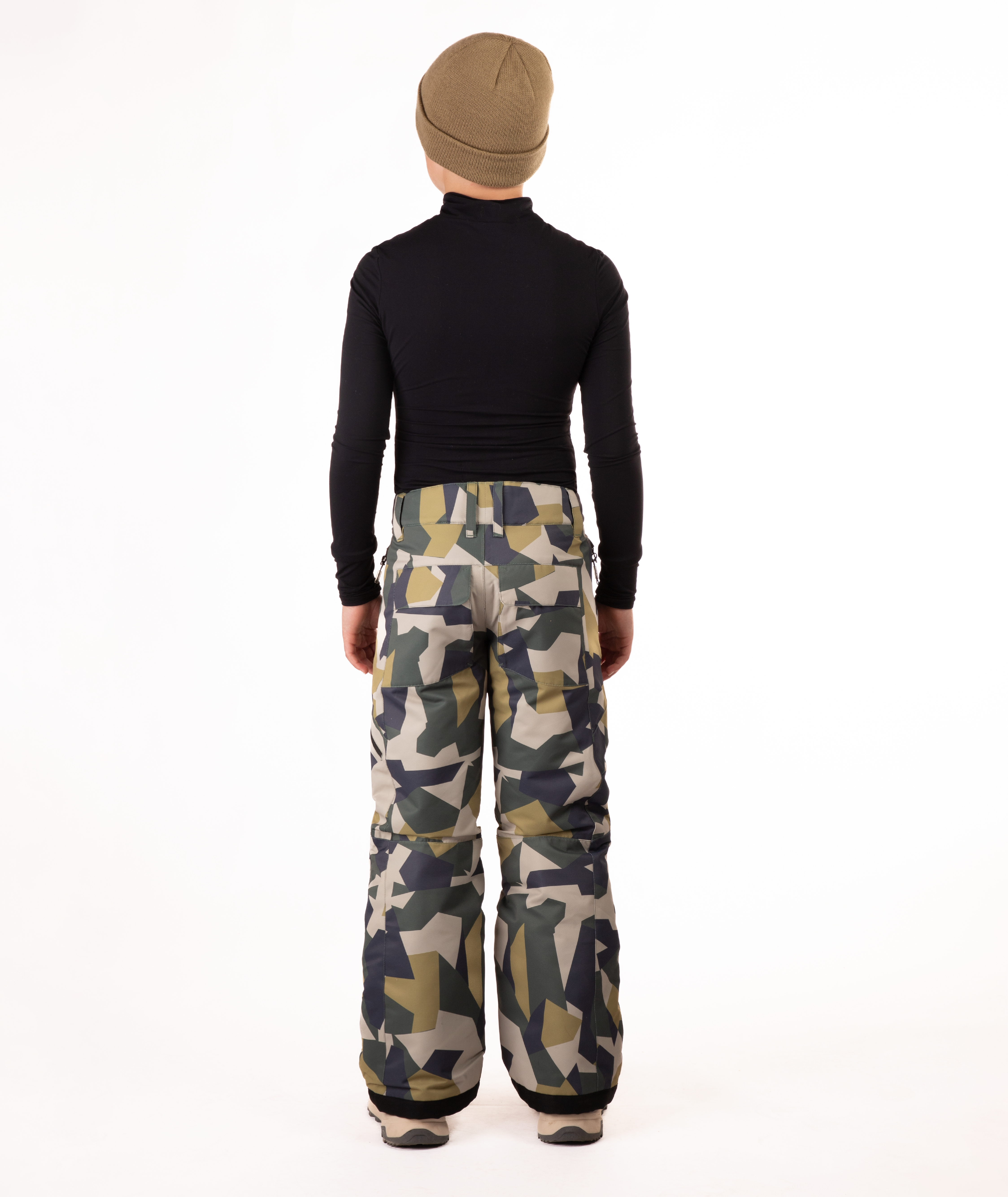 back of youth boy wearing a black long-sleeve shirt and camouflage snow pants on a white background