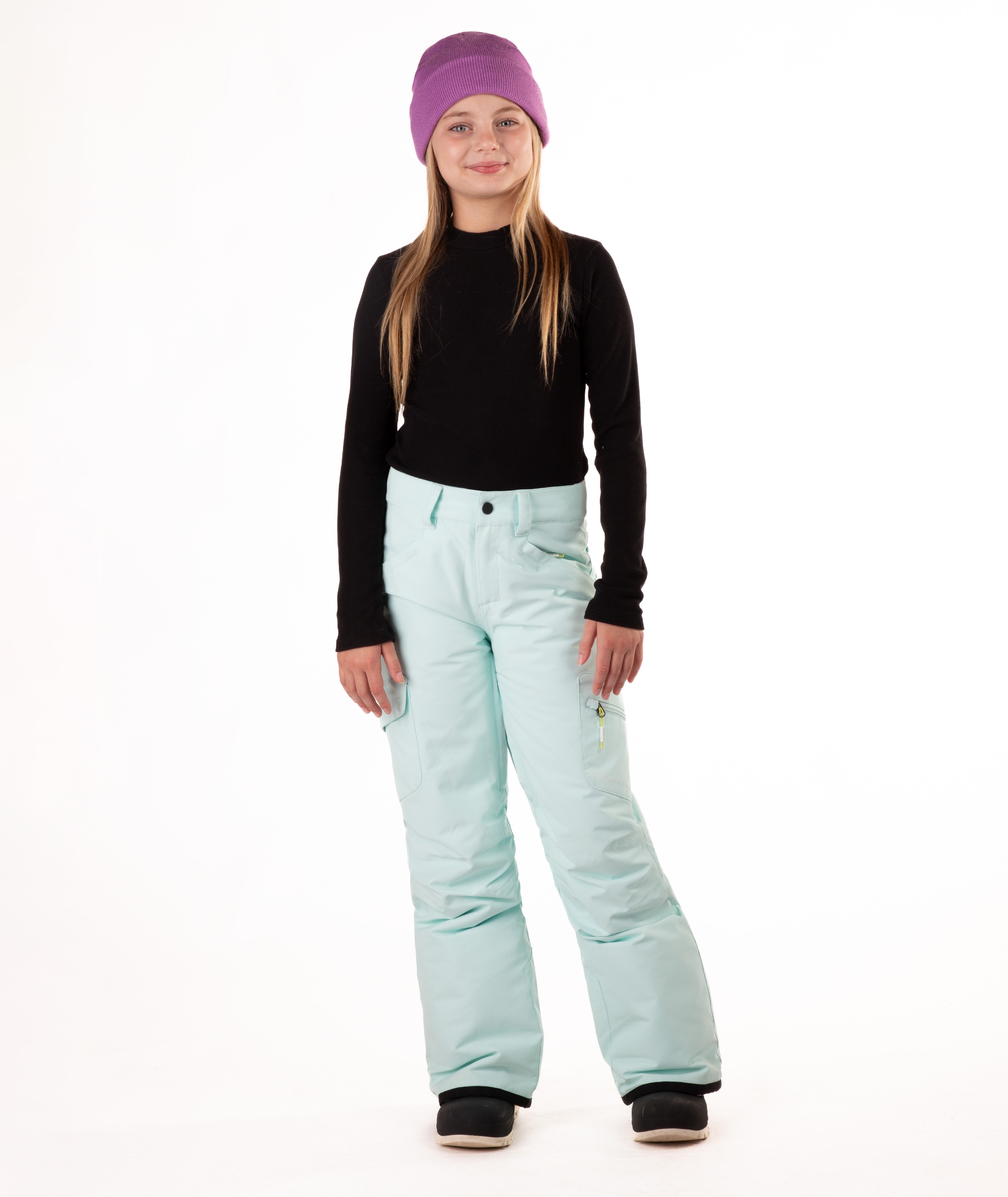 girl wearing light blue snow pants and a black long-sleeve top on a white background
