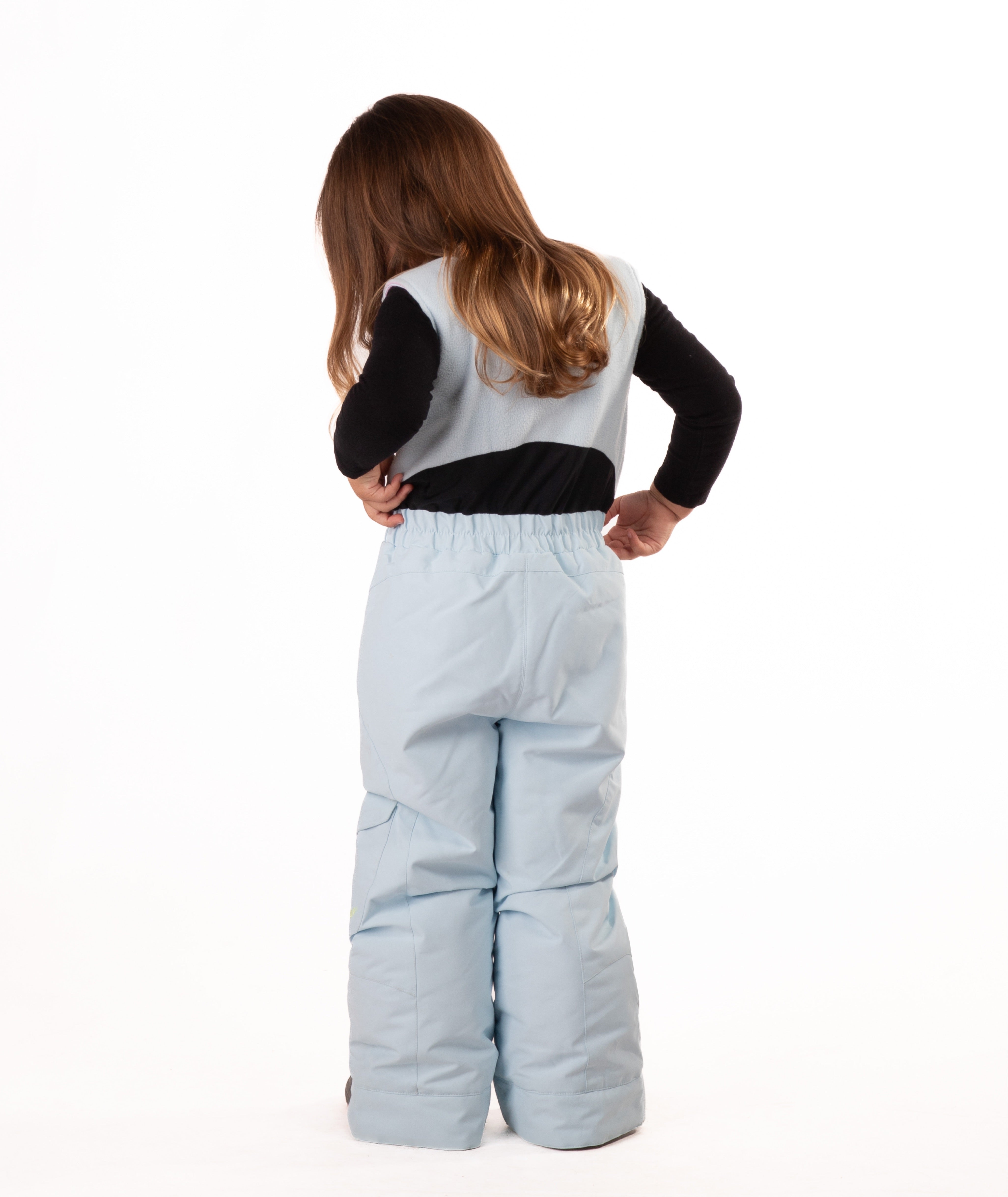 back of a child wearing a light blue snow bib with black top on a white background