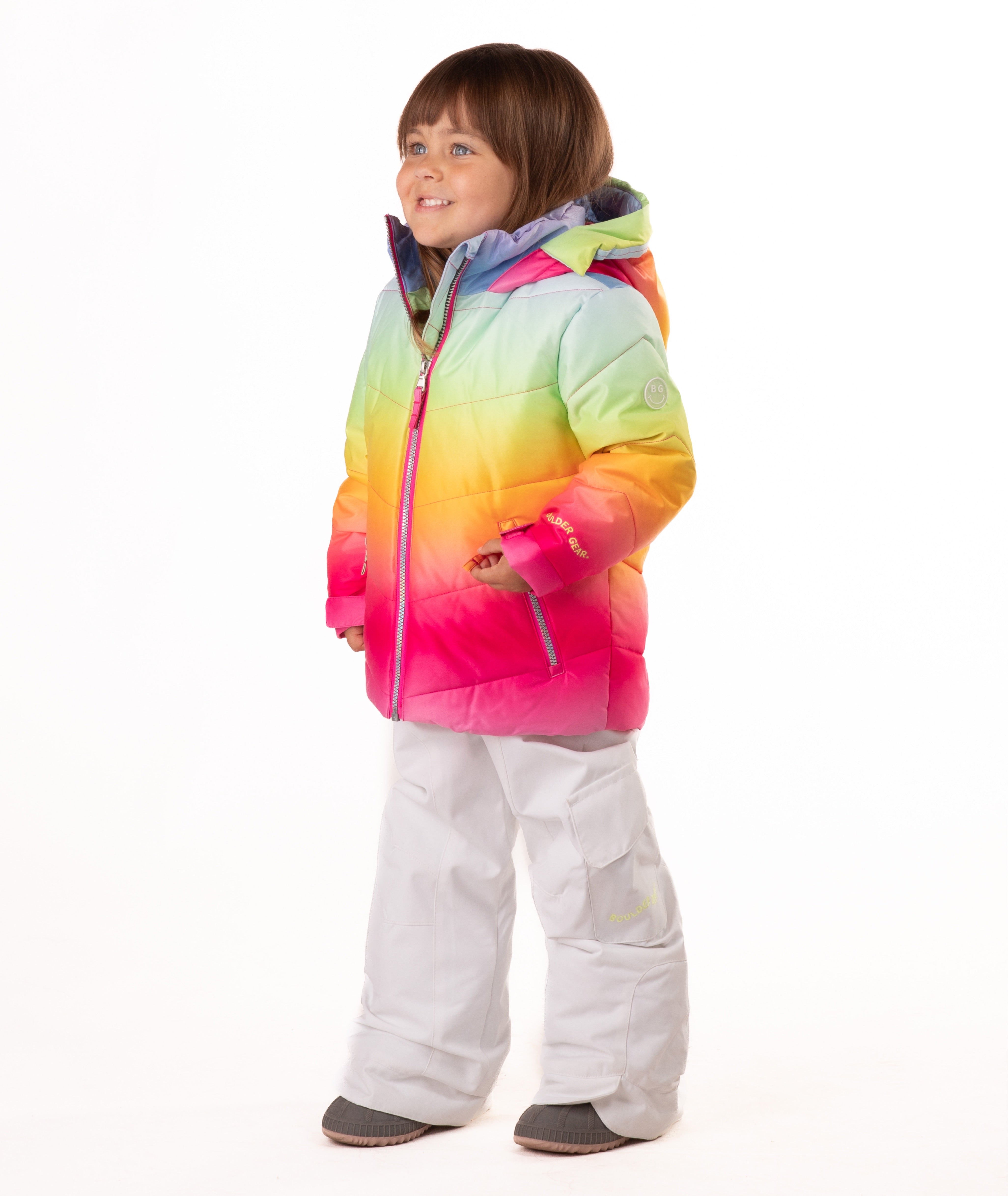 Child wearing a colorful gradient jacket and white pants on a white background
