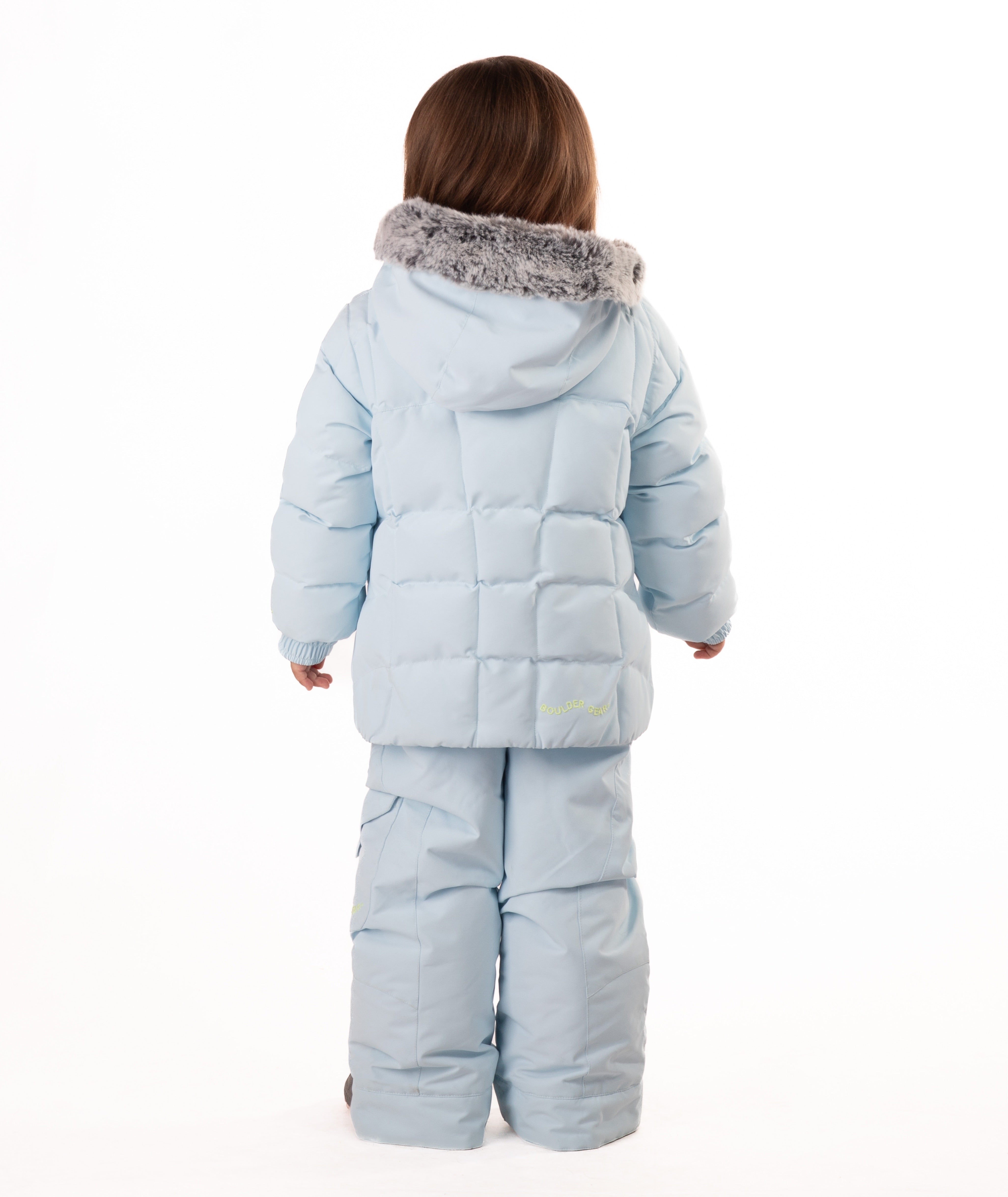 Child wearing a light blue quilted puffy winter coat with fur hood trim on a white background