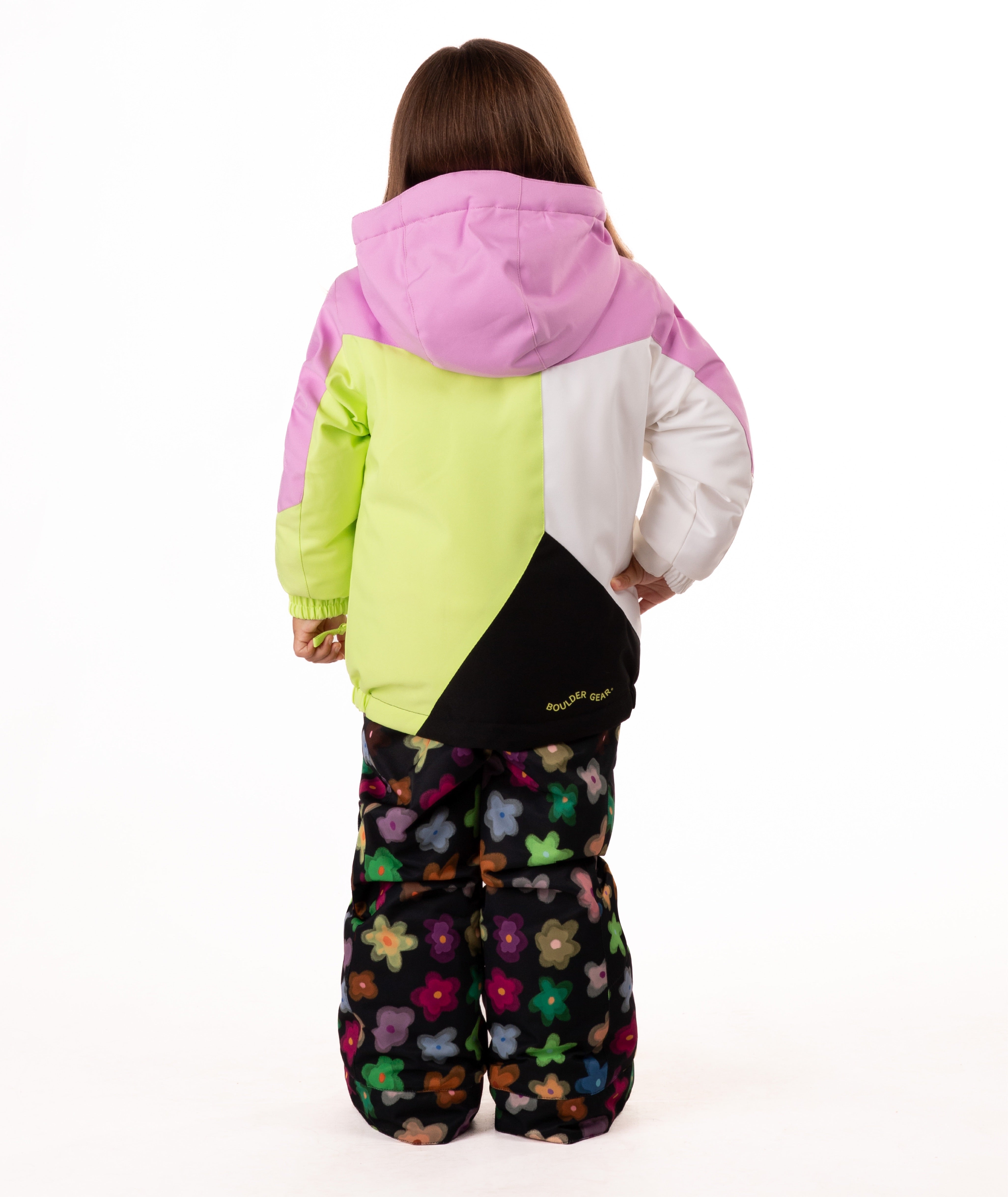 Child wearing a colorful jacket with pink, green, black, and white colors on a white background