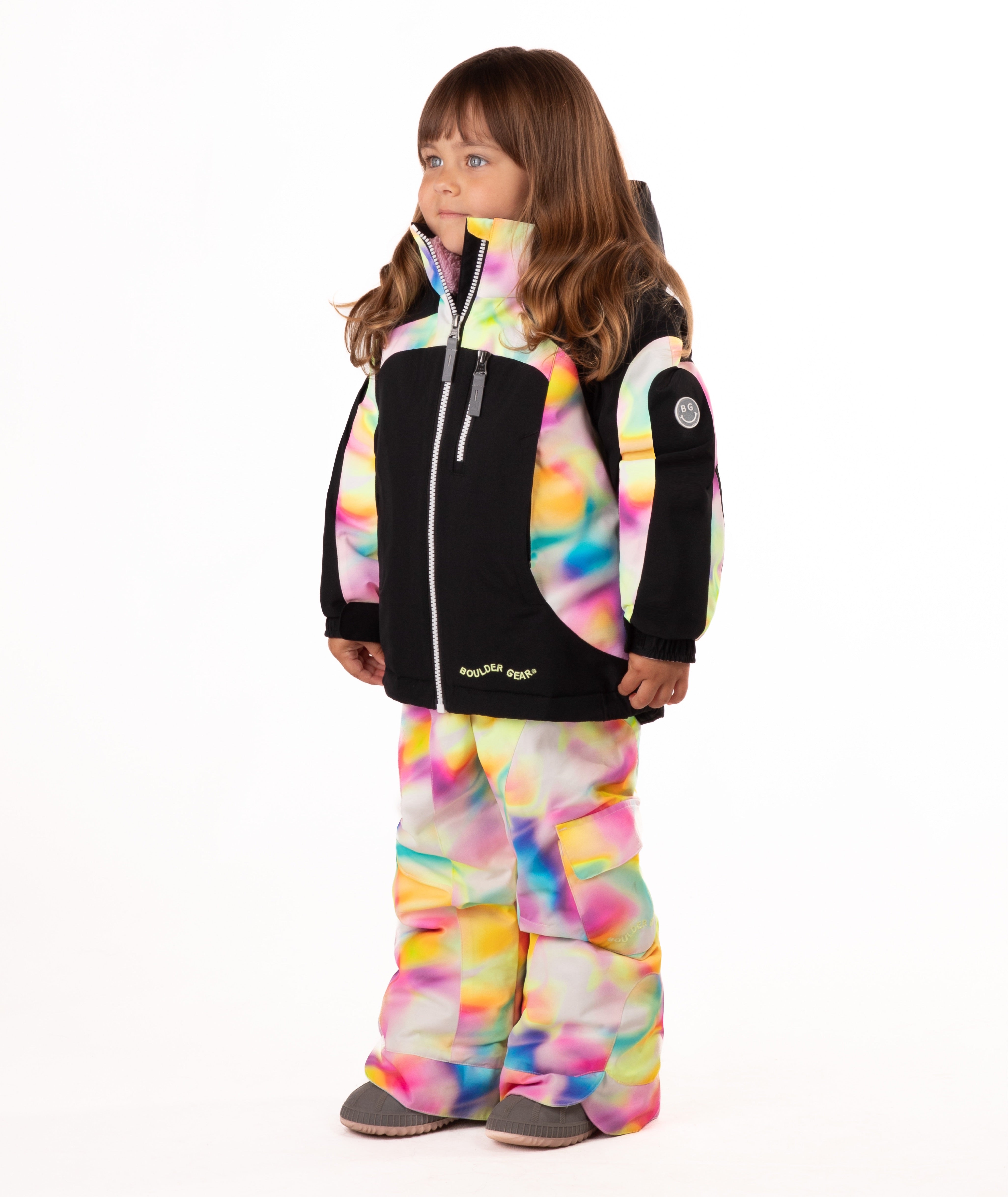 Child wearing a black winter jacket with pink, yellow, blue multi color trim on a white background