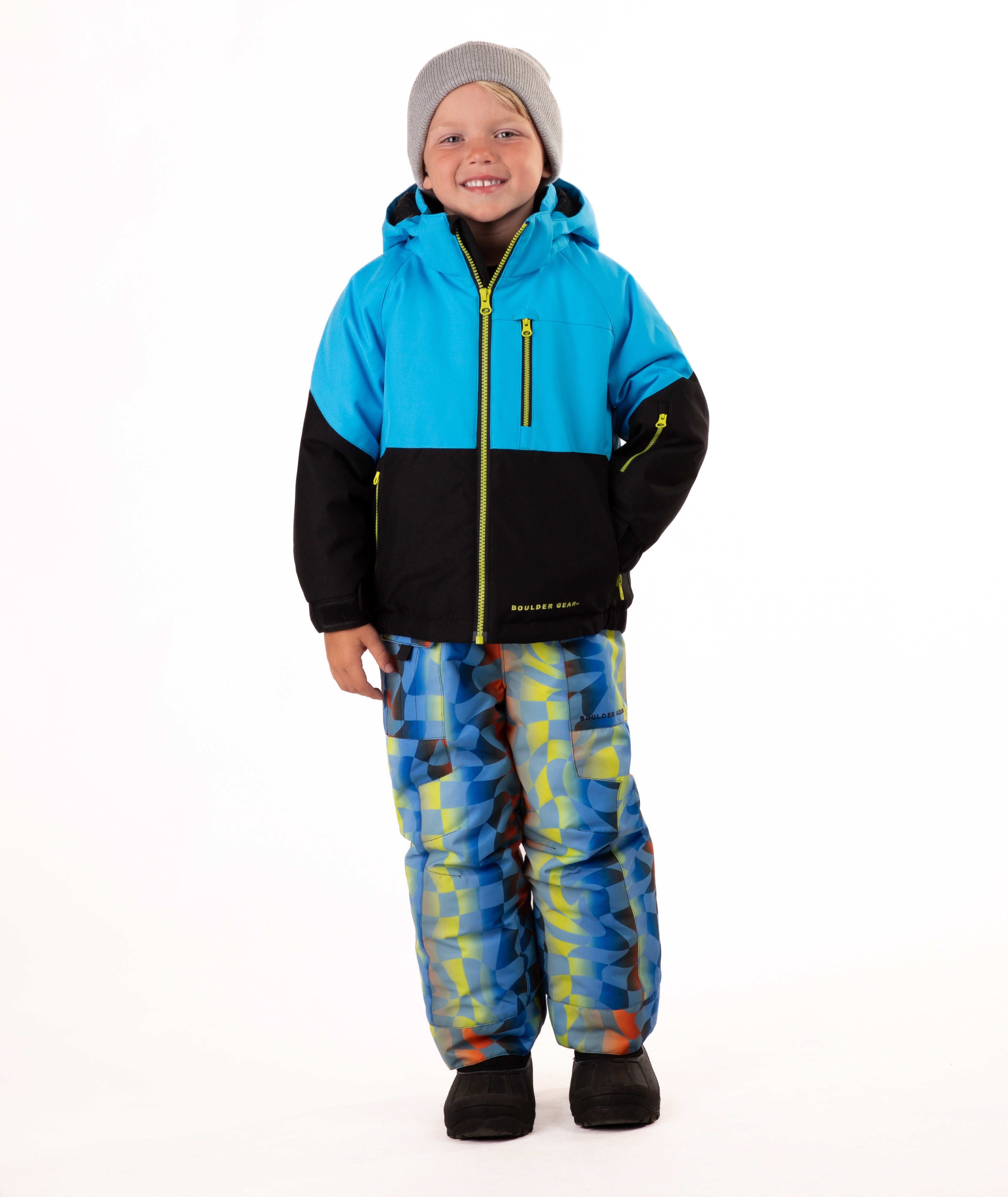 Child wearing a two-tone jacket with blue on the top and black on the bottom of the jacket on white background