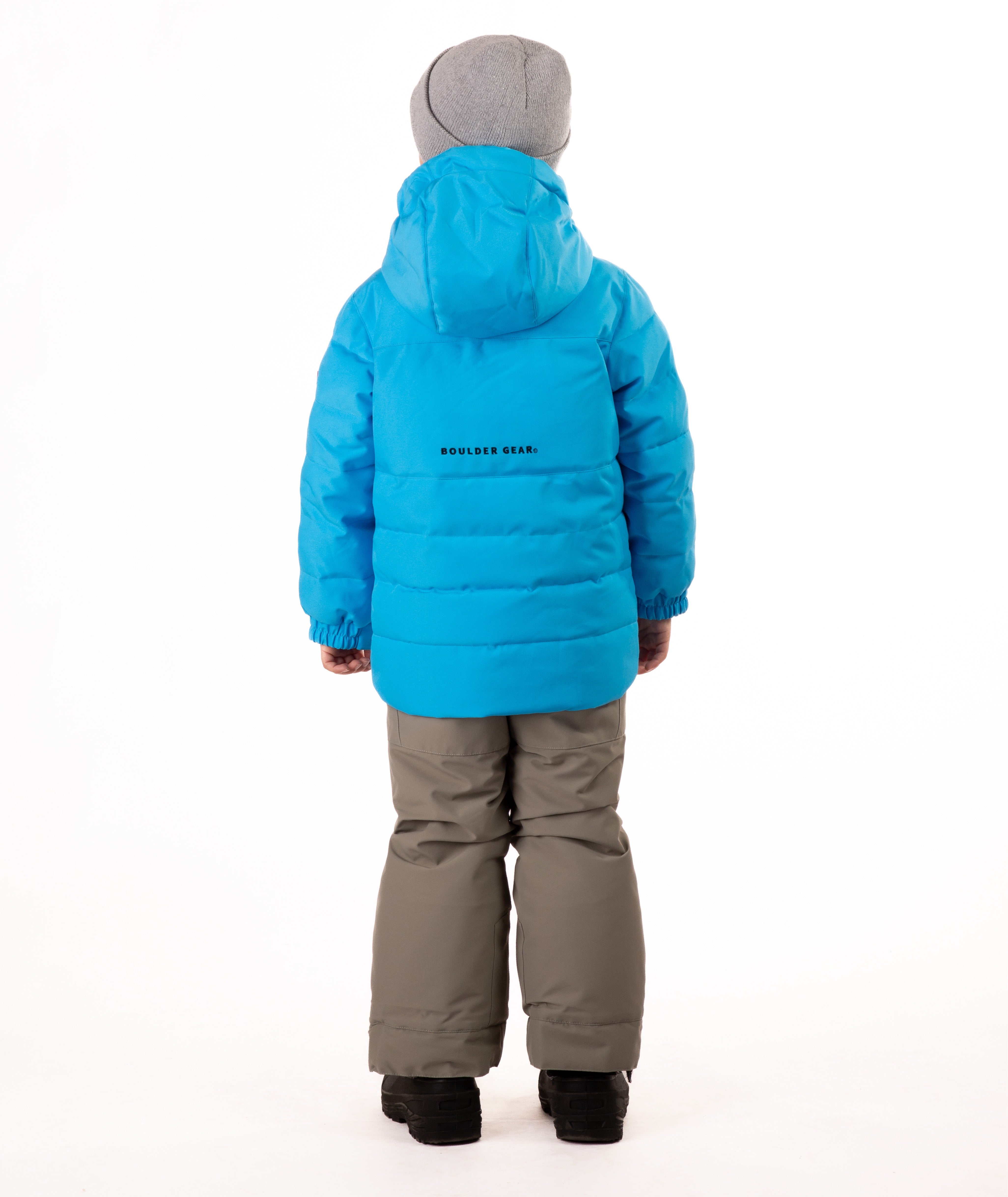 Child wearing a blue quilted winter jacket with chest pockets and hand-warmer pockets on a white background