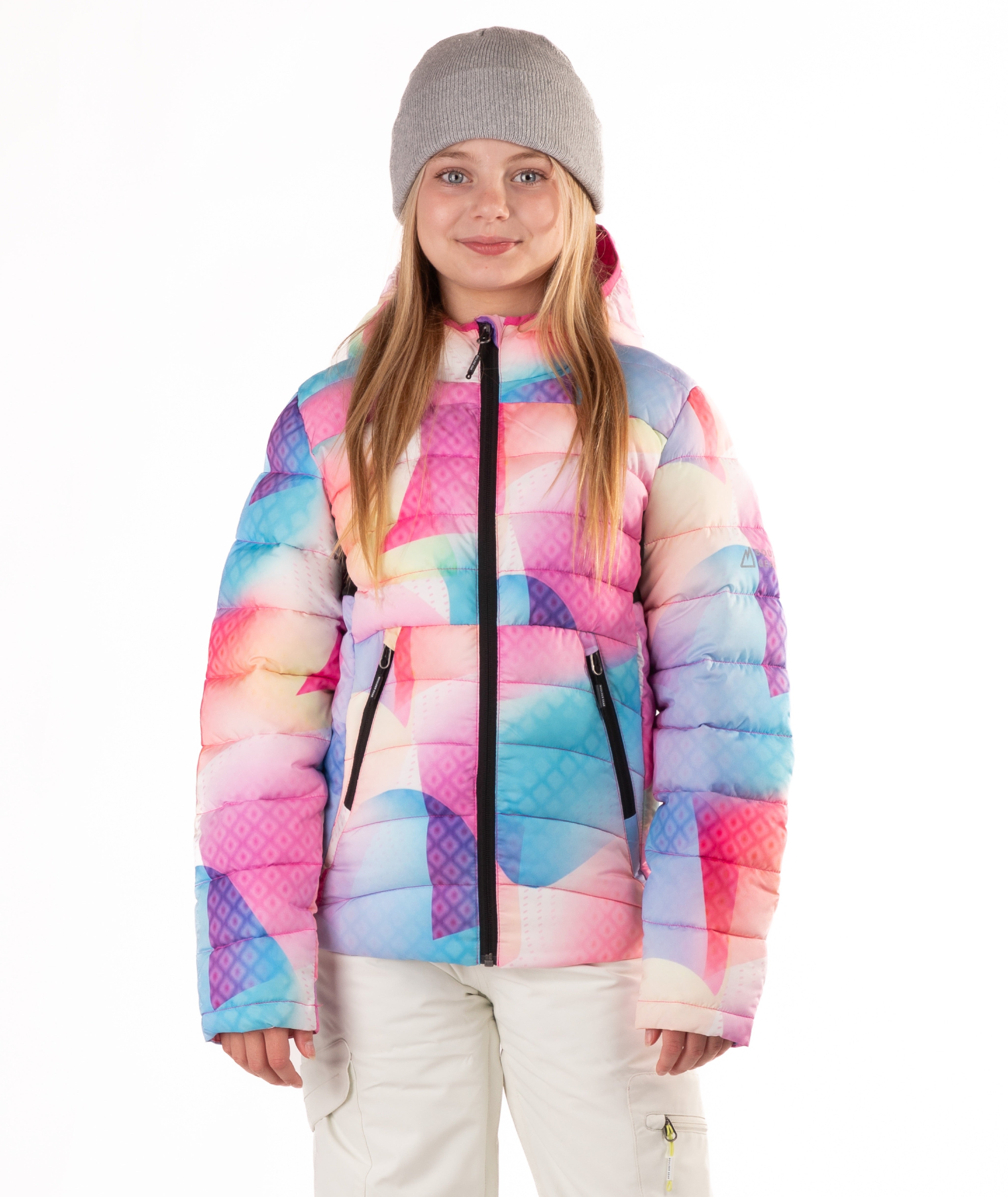 girl wearing a multi colored abstract pastel patterned puffer jacket on a white background