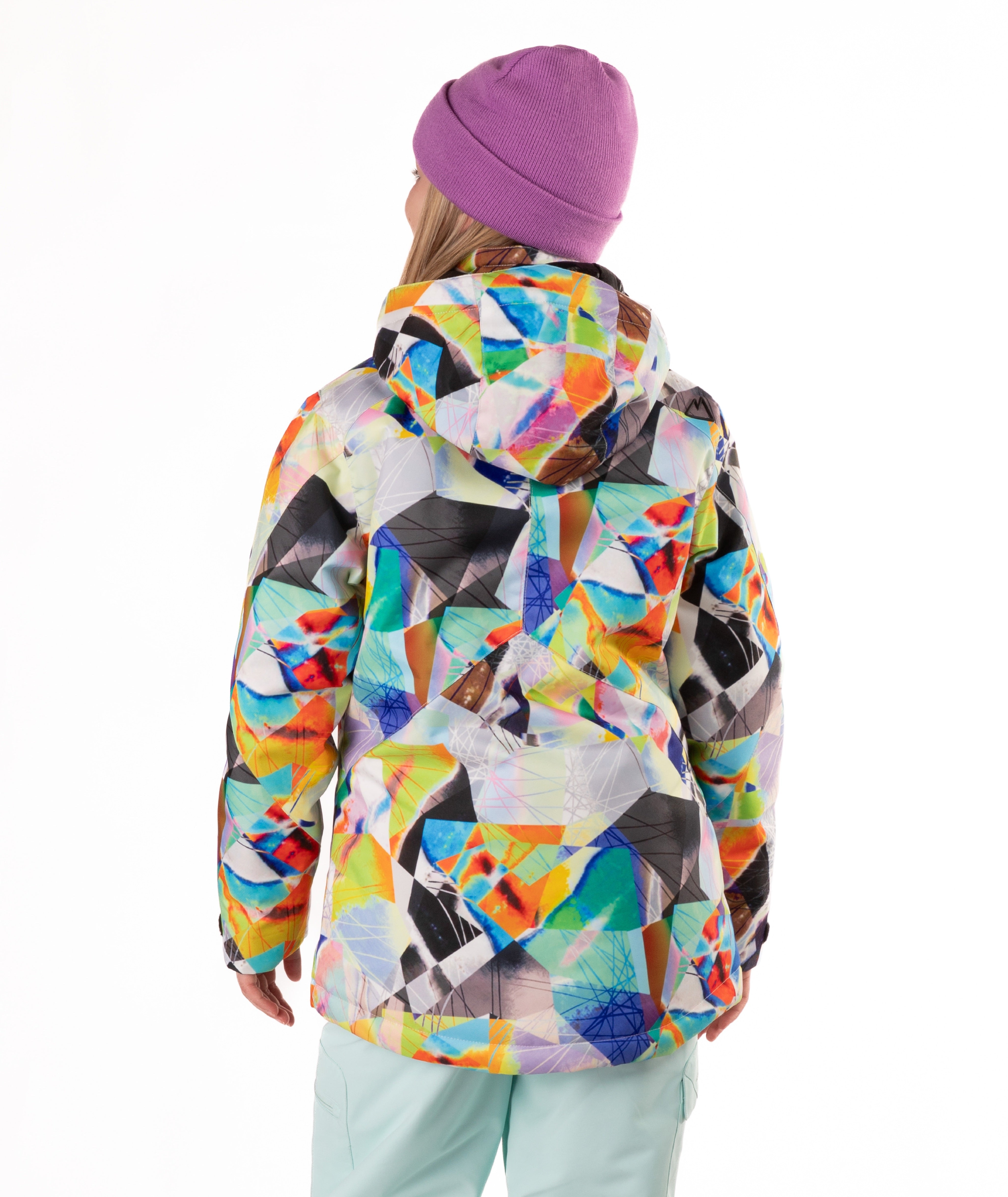 Youth girl wearing a colorful geometric-patterned jacket on a white background
