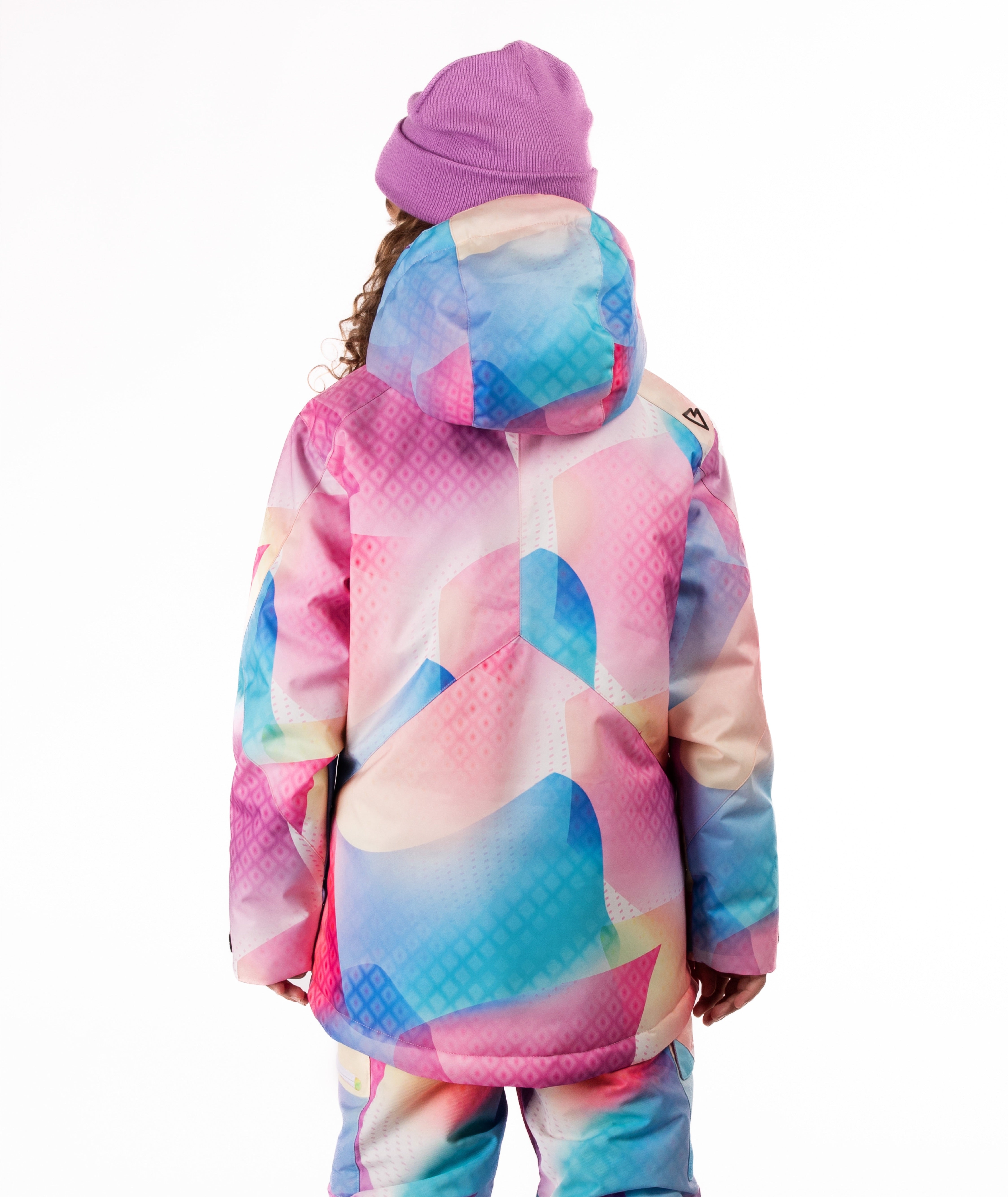 Child wearing a colorful geometric-patterned jacket on a white background